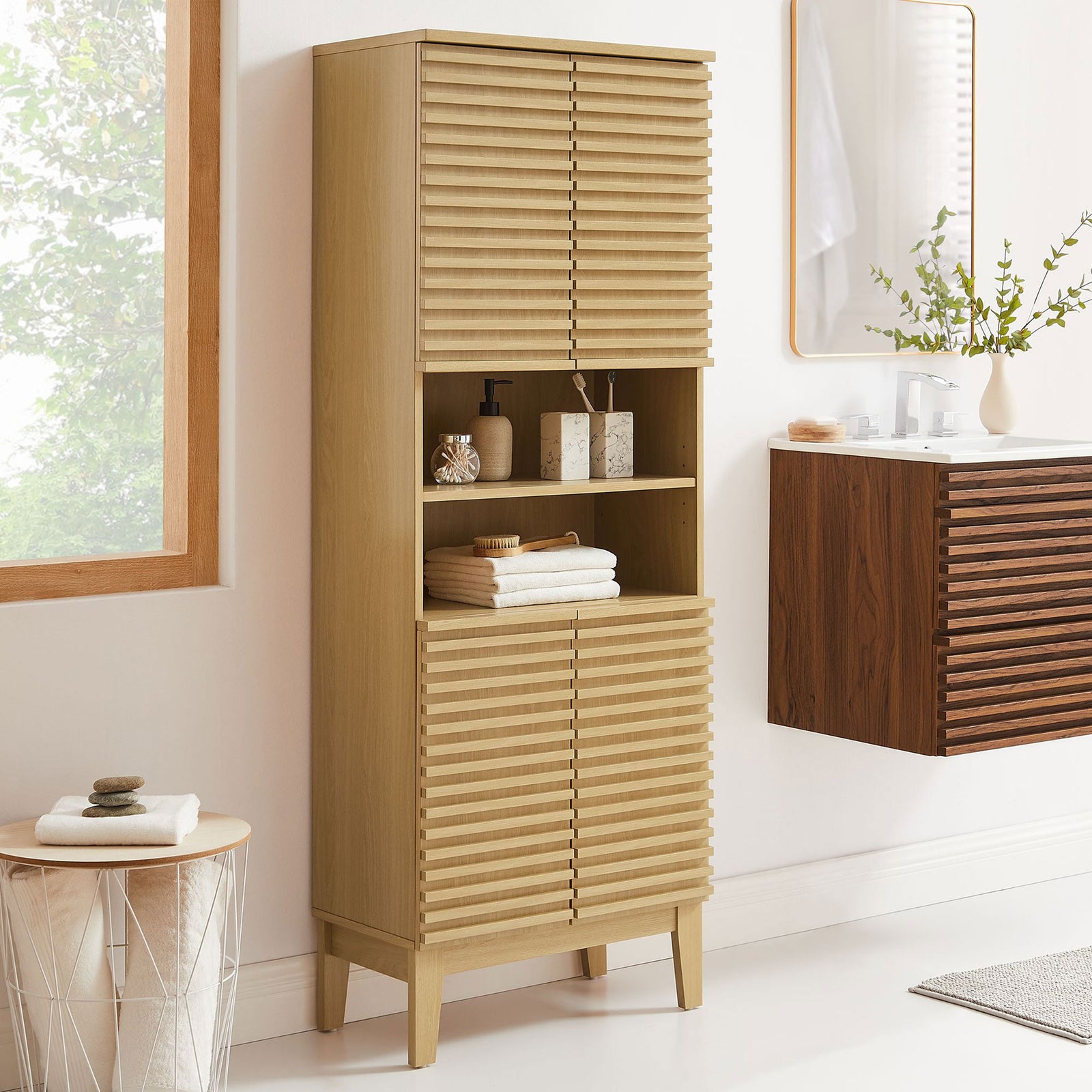 Bathroom-ready storage tower with warm oak finish, slatted doors, and open shelving || EEI-6852-OAK || front_angle_room