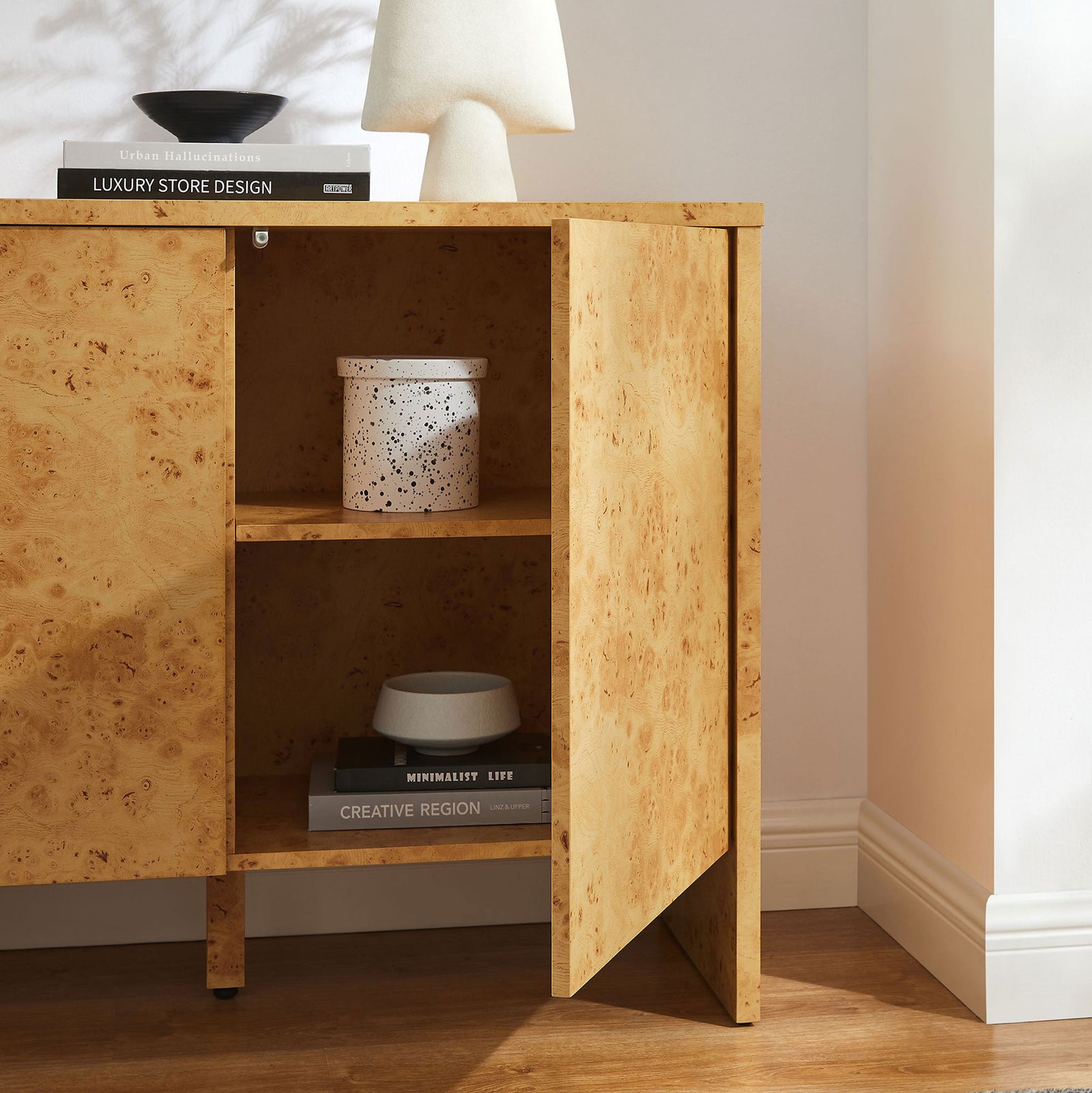 Styled Hudson burl sideboard in a bright room, with open shelving ready to store serveware and decor. || EEI-6859-BUR || storage_open_room