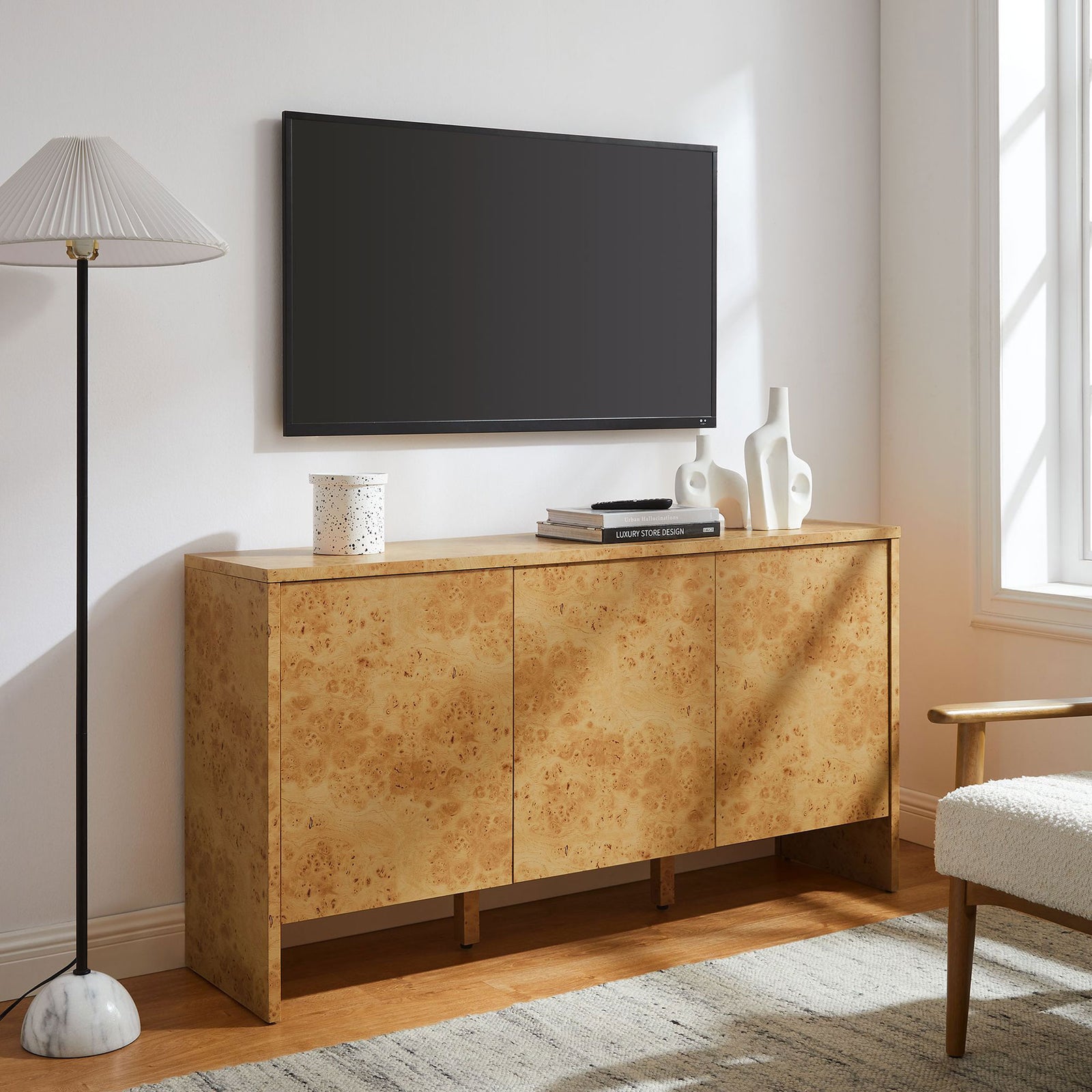 Hudson burl wood sideboard used as a media console beneath a wall mounted television || EEI-6860-BUR || front_angle_room