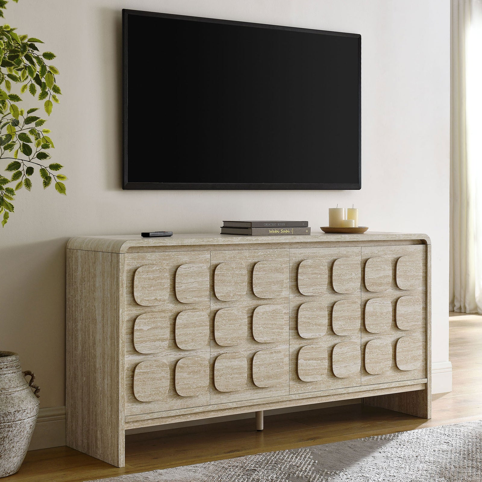 Toscana sideboard styled in a bright living room beneath a wall mounted TV and decor accents || EEI-6862-TRA || front_angle_room