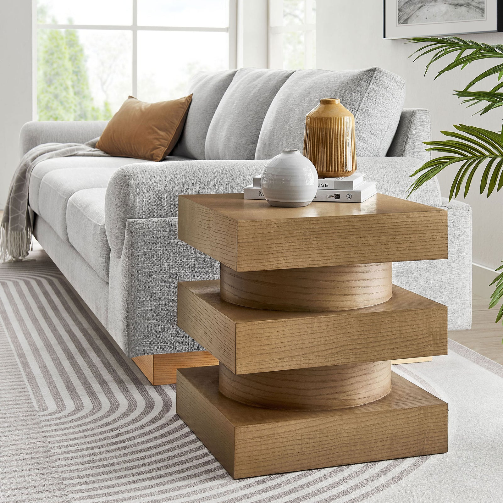 Perpetuate totem end table anchoring a modern living room with soft upholstery and layered texture || EEI-6864-CAS || front_angle_room