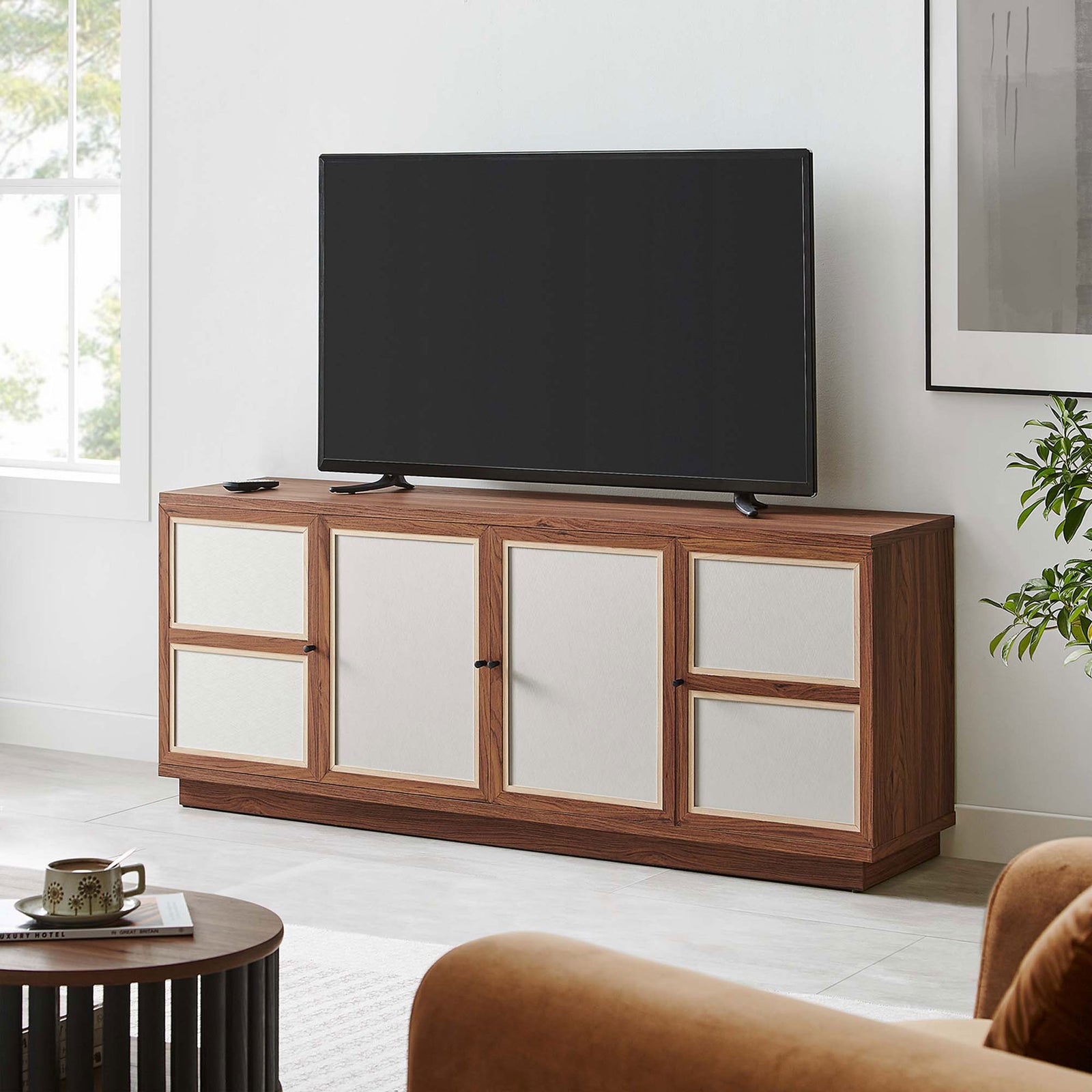 Walnut Capri TV console styled with a large television, anchoring a cozy modern living room setup || EEI-6865-WAL || front_angle_room