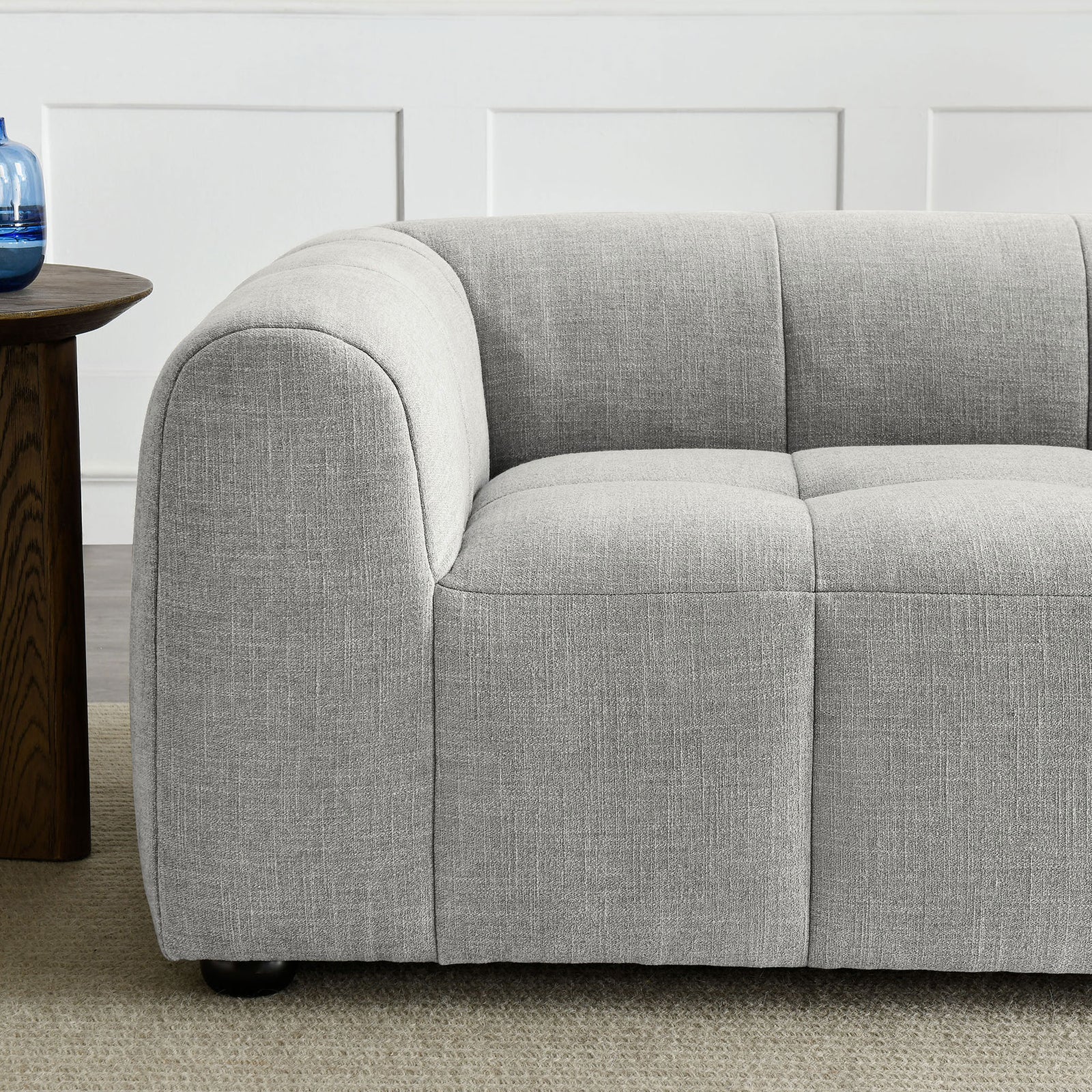 Cozy pewter loveseat arm and seat showing soft textured fabric and inviting deep cushioning beside a wood side table || EEI-6867-PEW || detail_room
