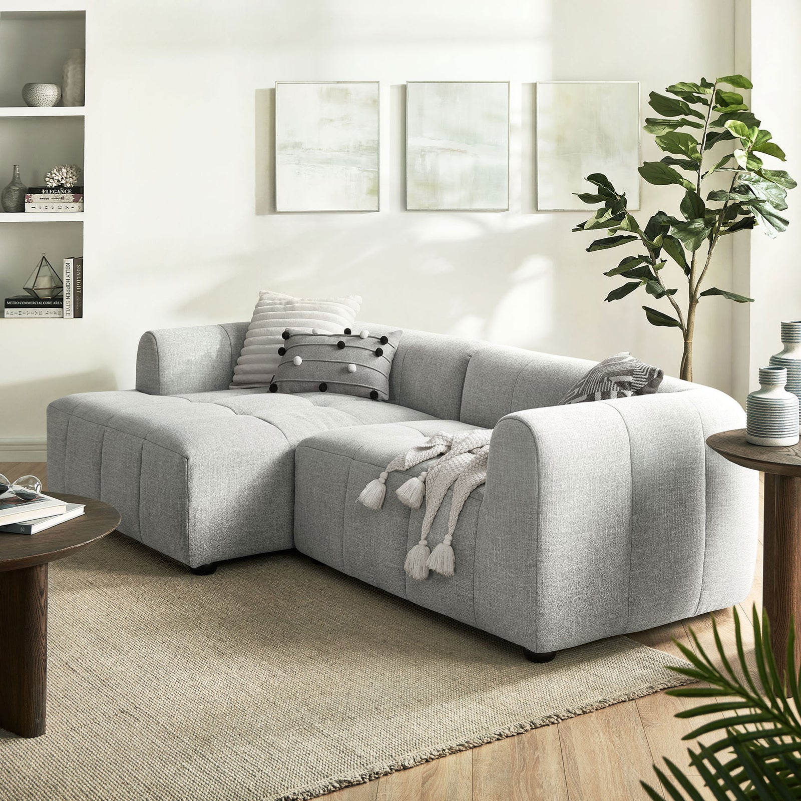 Liana left-facing sectional styled in a bright living room with accent pillows and neutral rug. || EEI-6868-PEW || front_angle_room