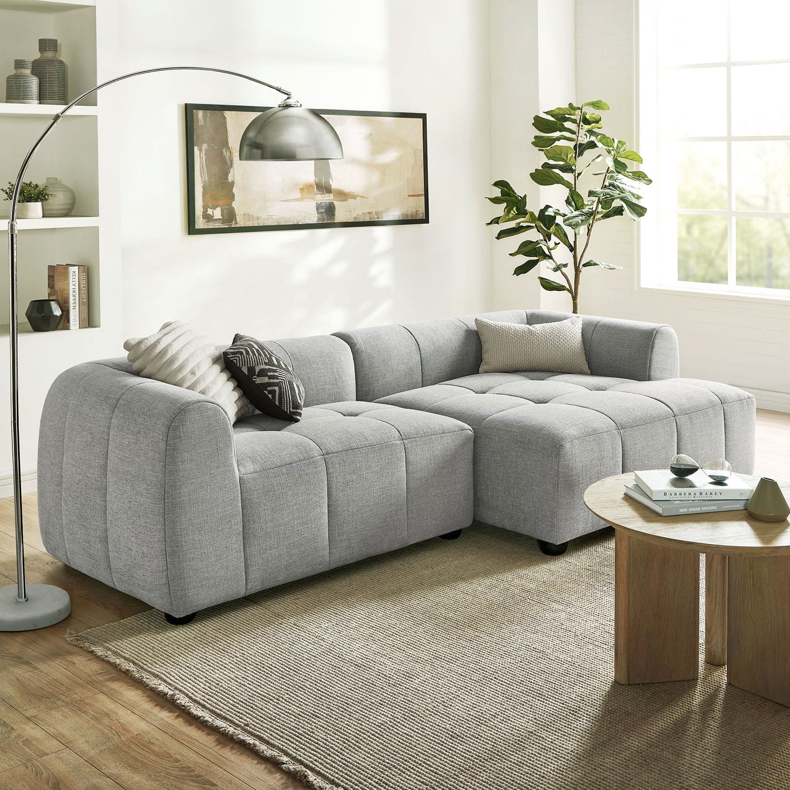 Liana right-facing sectional arranged in a modern living room with floor lamp, rug, and coffee table. || EEI-6869-PEW || front_angle_room