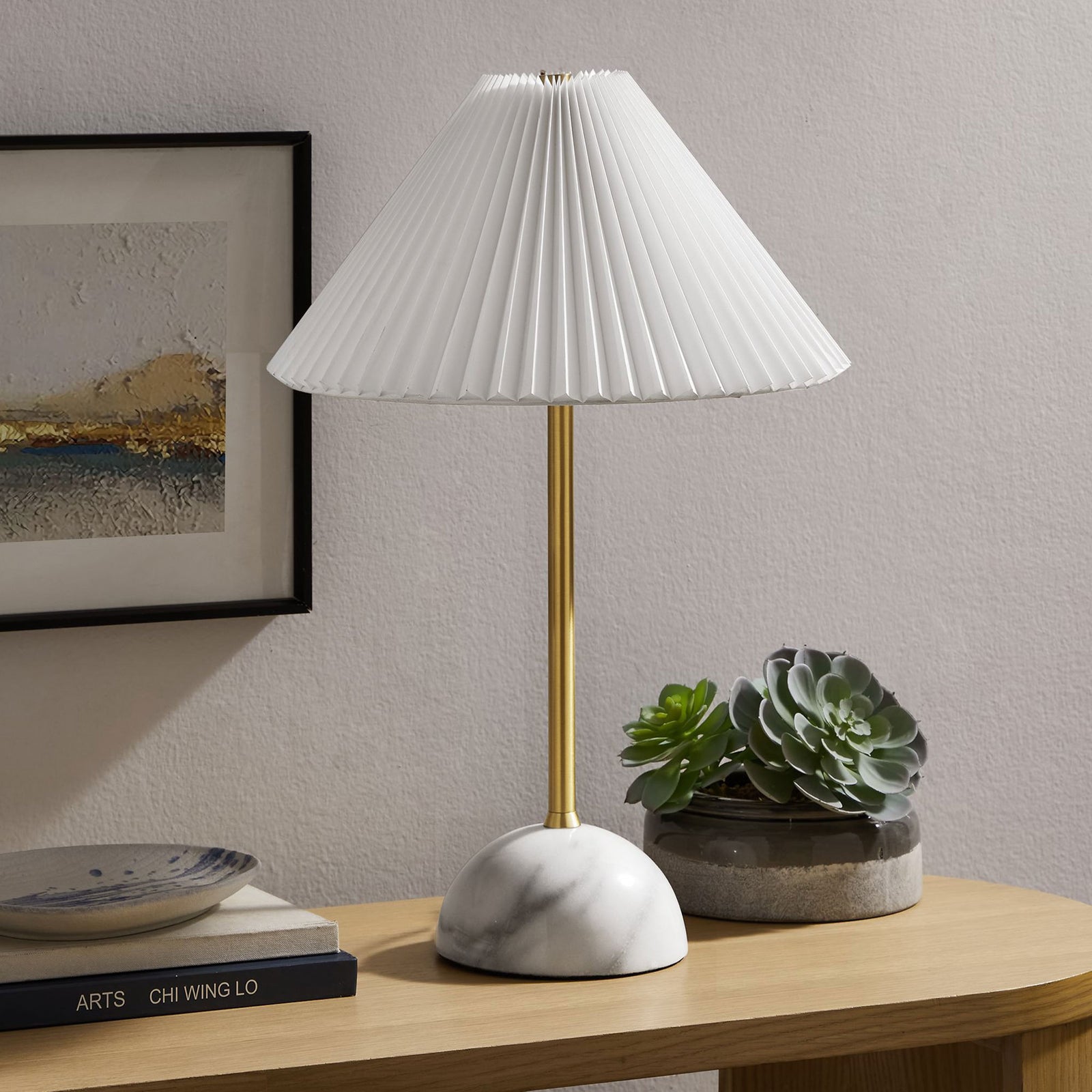 Illusion lamp styled on a console table with brass stem, marble dome base, and pleated white shade. || EEI-6878-BRA || front_angle_room