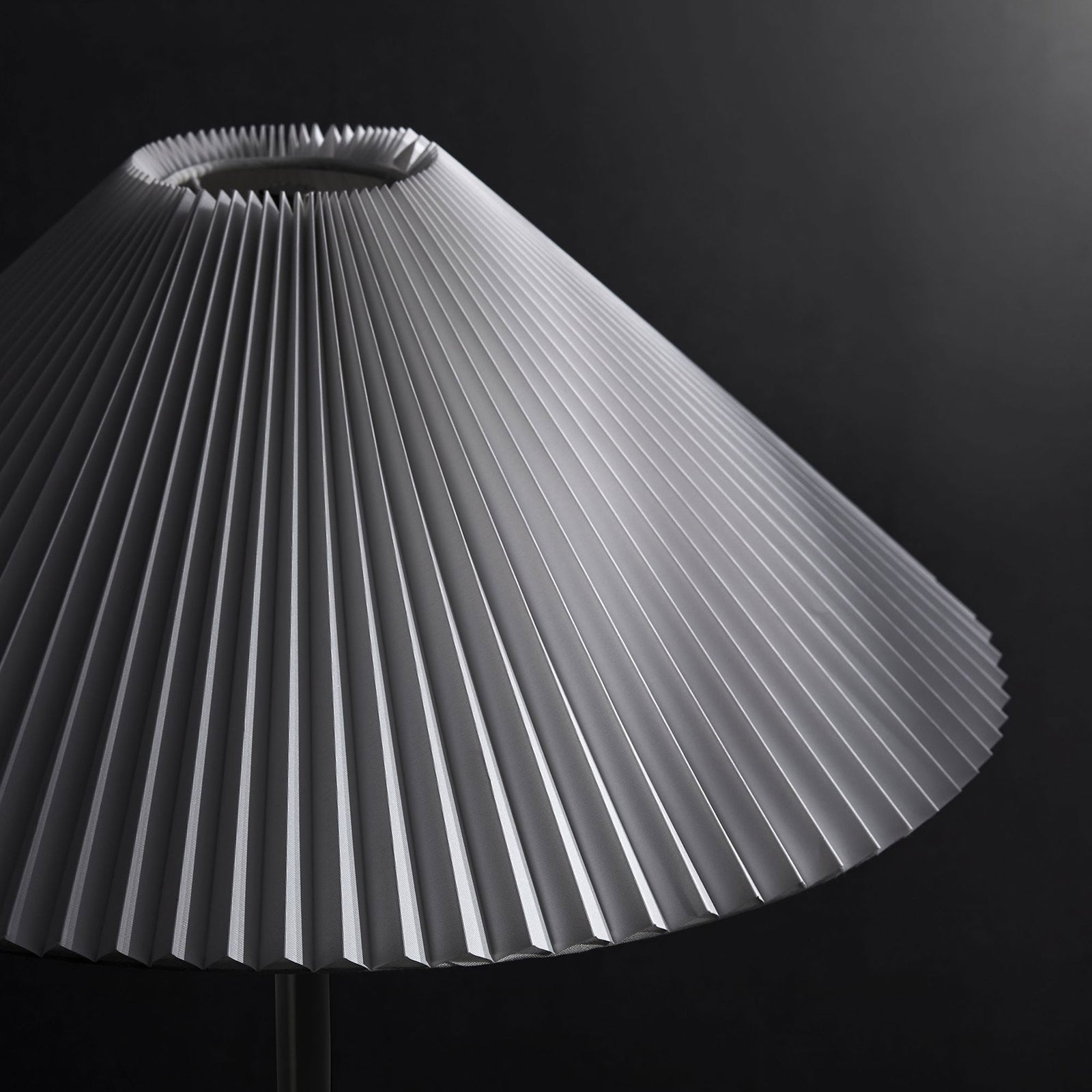 Illusion floor lamp shade with bold pleated texture standing out against a dark modern backdrop || EEI-6879-BLK || shade_studio
