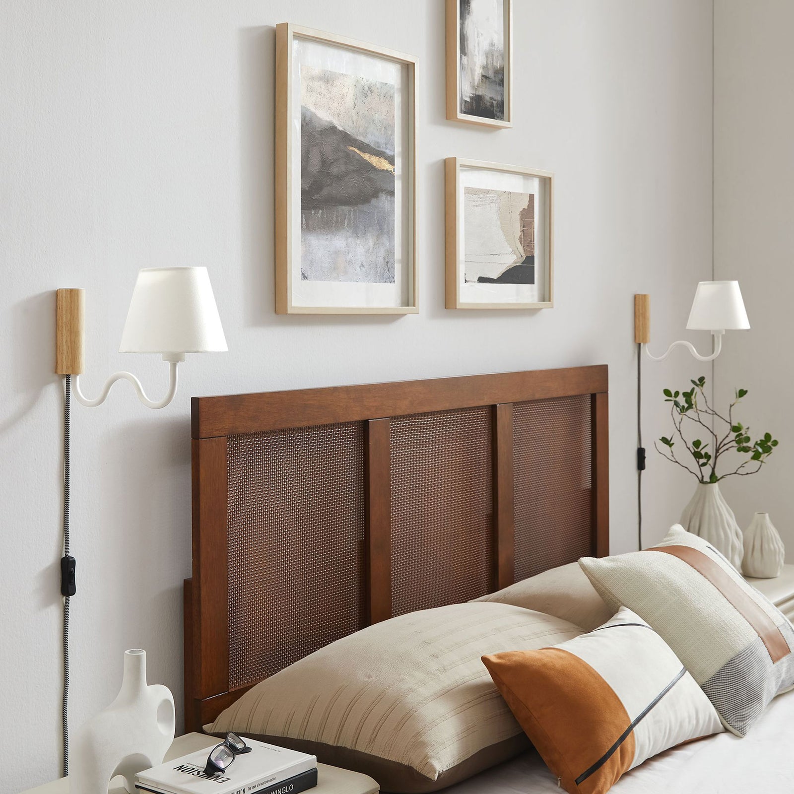 Pair of natural wood and white squiggle wall sconces brighten a modern bedroom above the headboard || EEI-6881-NAT-WHI || front_angle_room