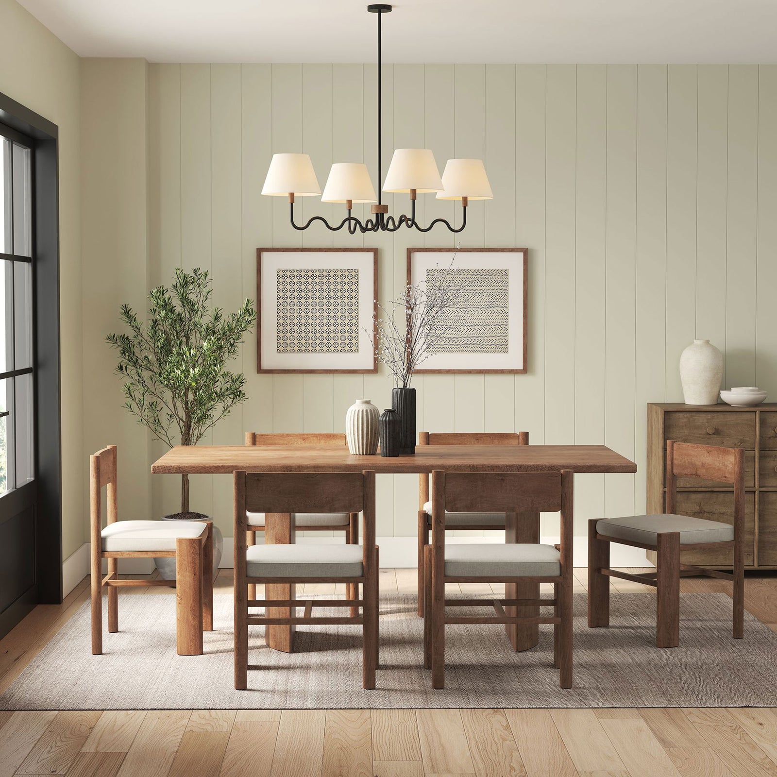 Modern four light pendant adds inviting charm above a dining table with its sculptural curves || EEI-6883-WAL-BLK || front_on_room