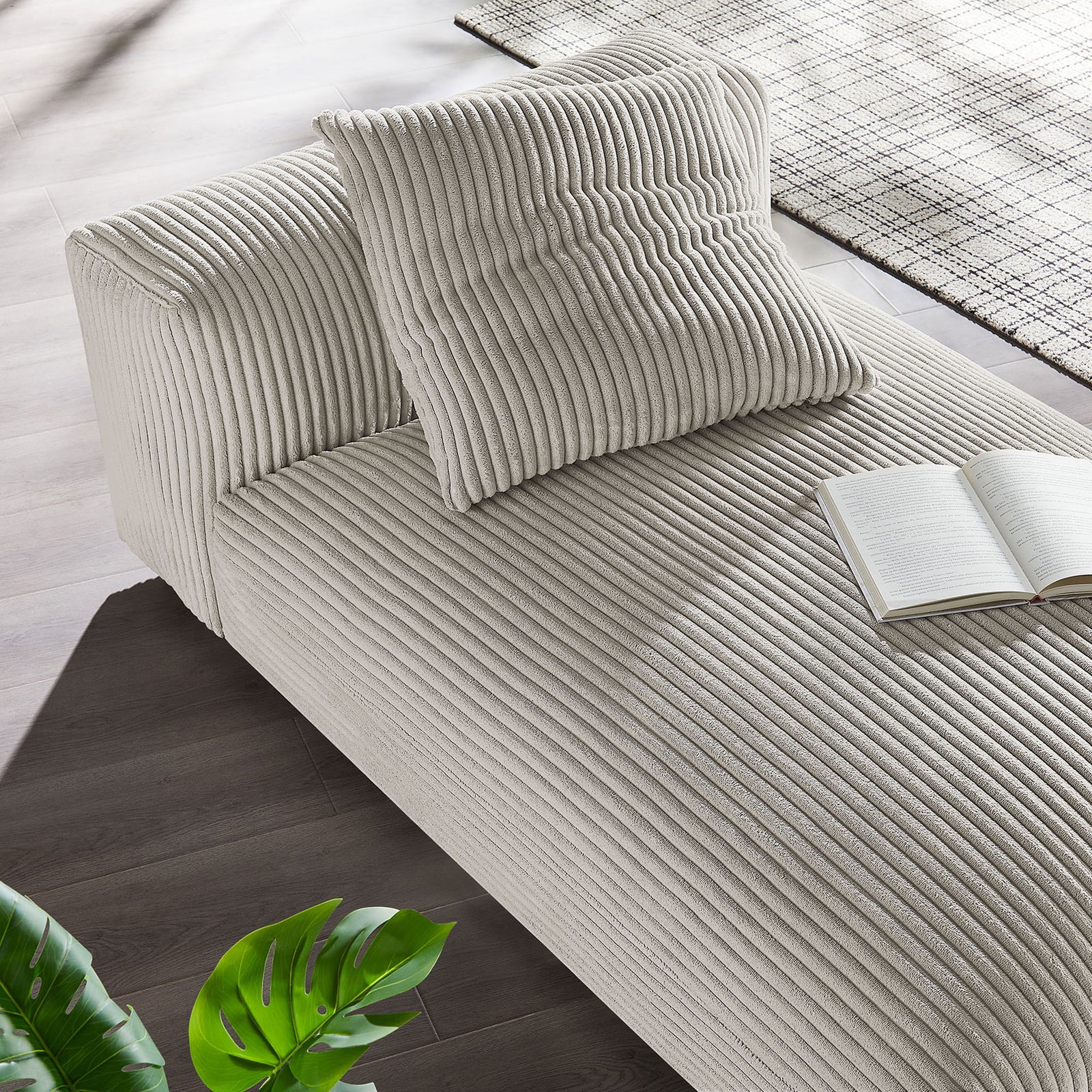 Relaxed chaise styled in a modern living space, accented with a pillow and soft almond corduroy || EEI-6886-ALM || top_angle_room
