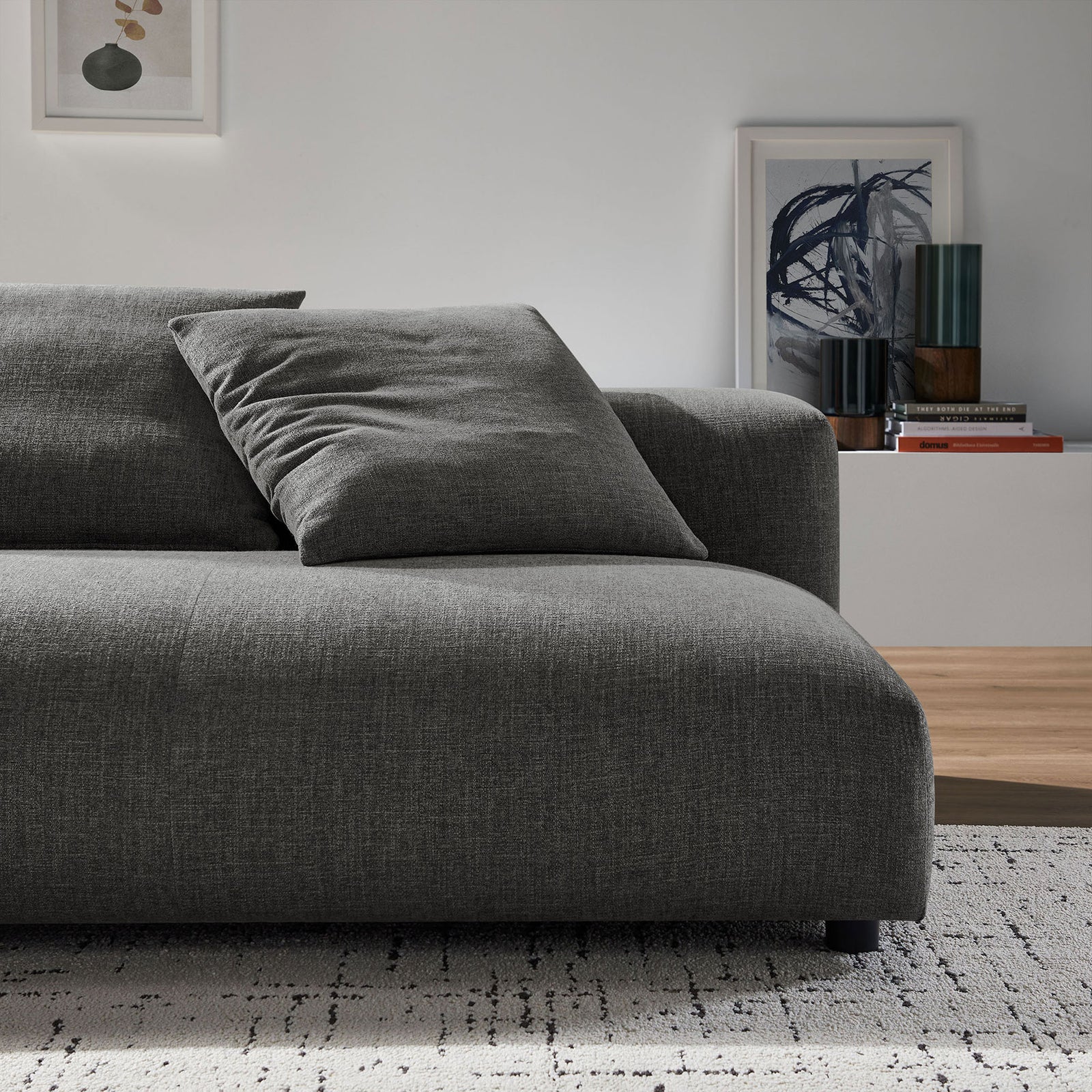 Charcoal modular loveseat styled in a modern living room with neutral rug and decorative accents. || EEI-6891-CHA || detail_room