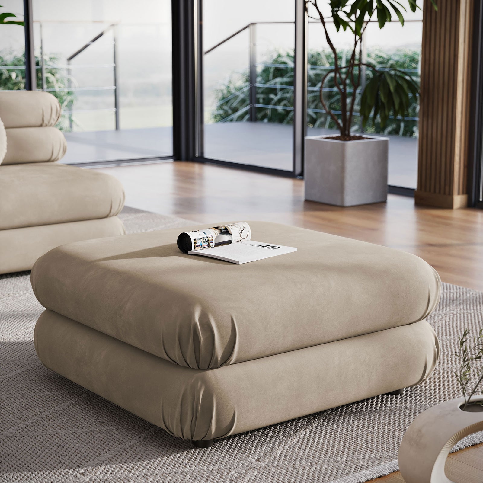 Plush taupe ottoman anchors a bright lounge space, pairing with modular seating for flexible comfort || EEI-6899-TAU || front_angle_room
