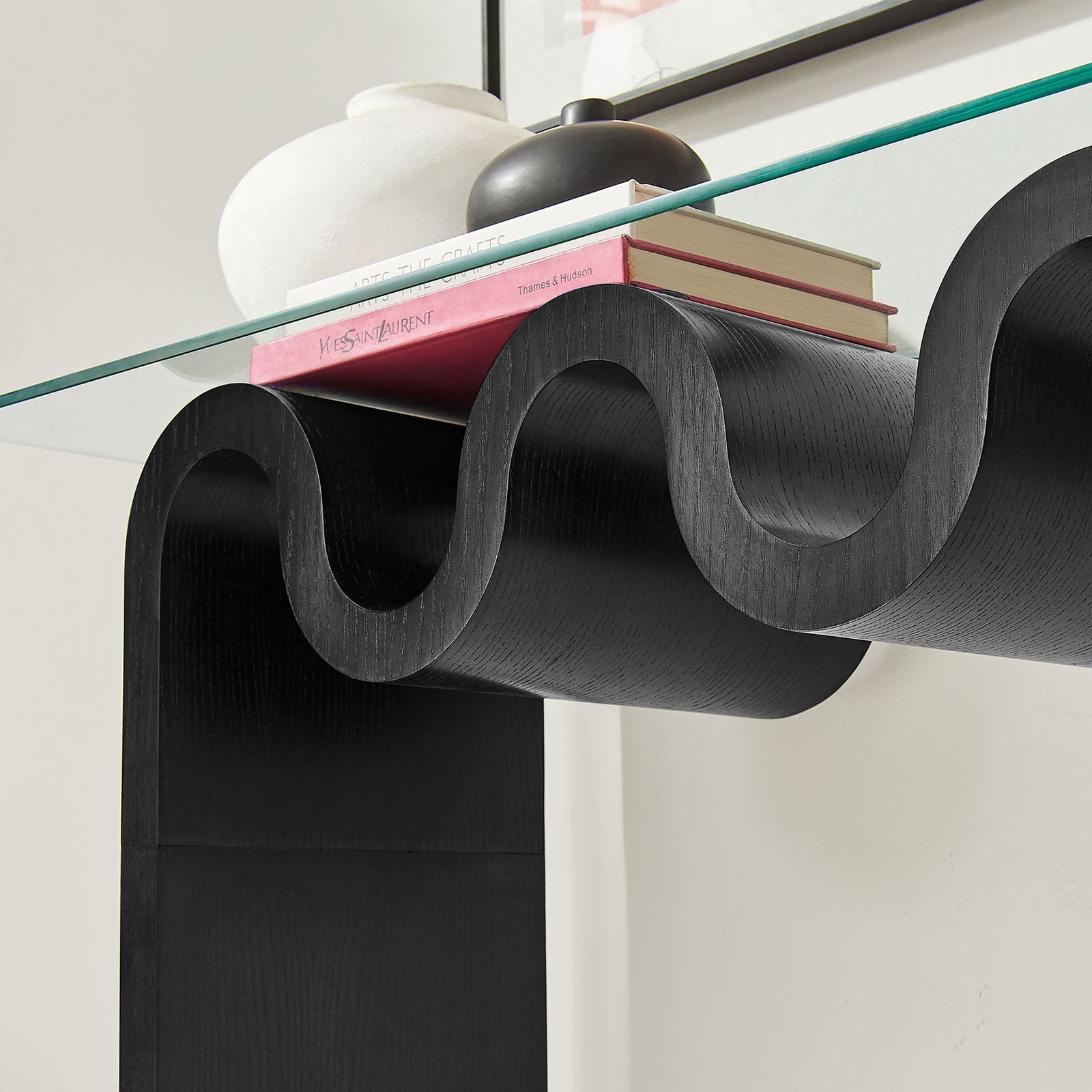 Wave base supports books and decor while keeping a light, airy look under the glass. || EEI-6901-BLK || detail_room
