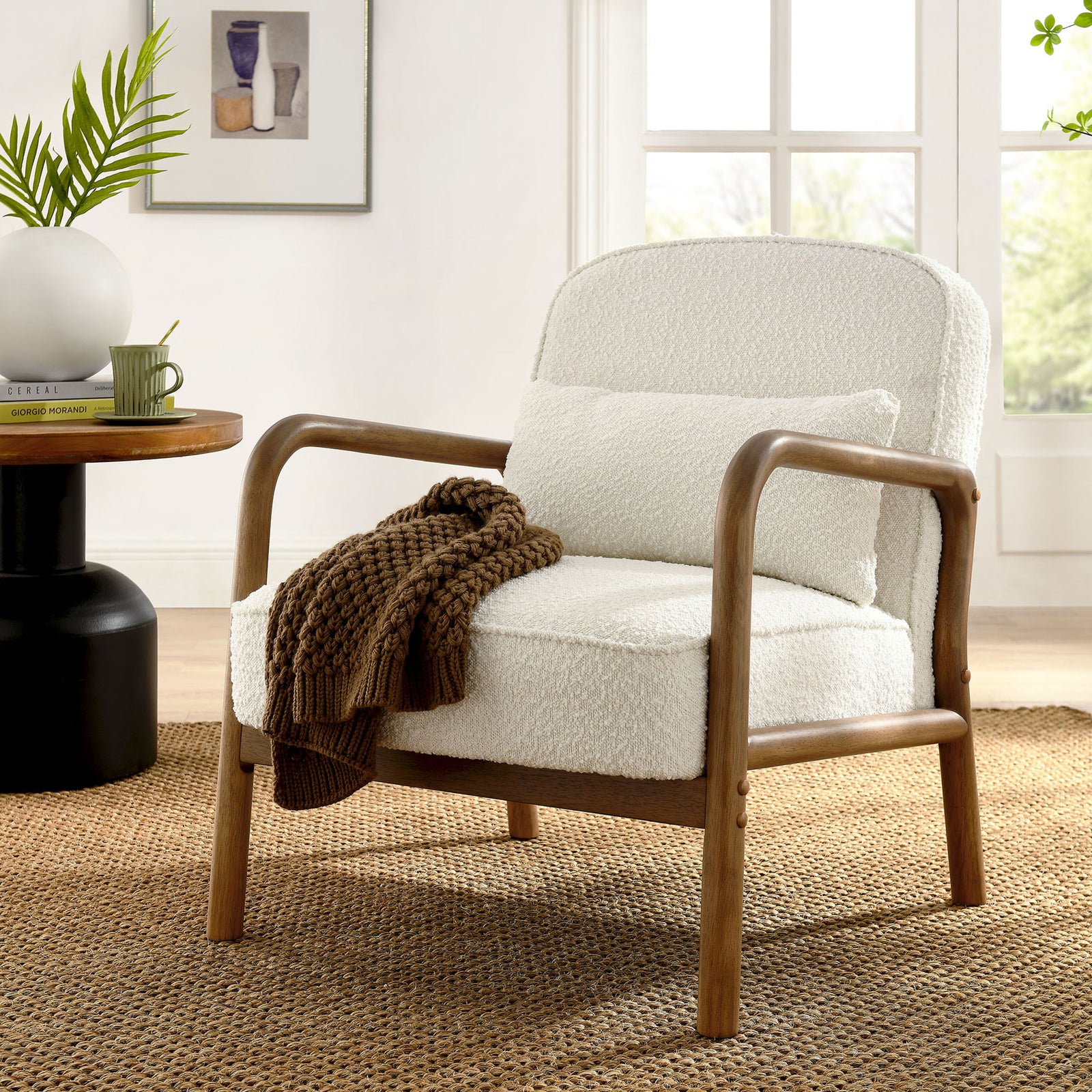 Inviting ivory boucle armchair with curved wooden arms and matching pillow warms the space || EEI-6909-IVO || front_angle_room