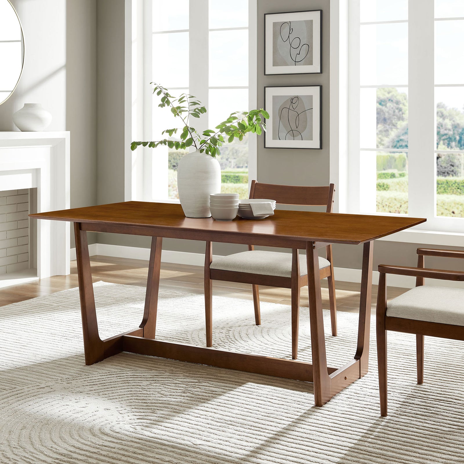 Solara walnut dining table styled with coordinating chairs and decor in a modern light-filled dining room || EEI-6914-WAL || front_angle_room