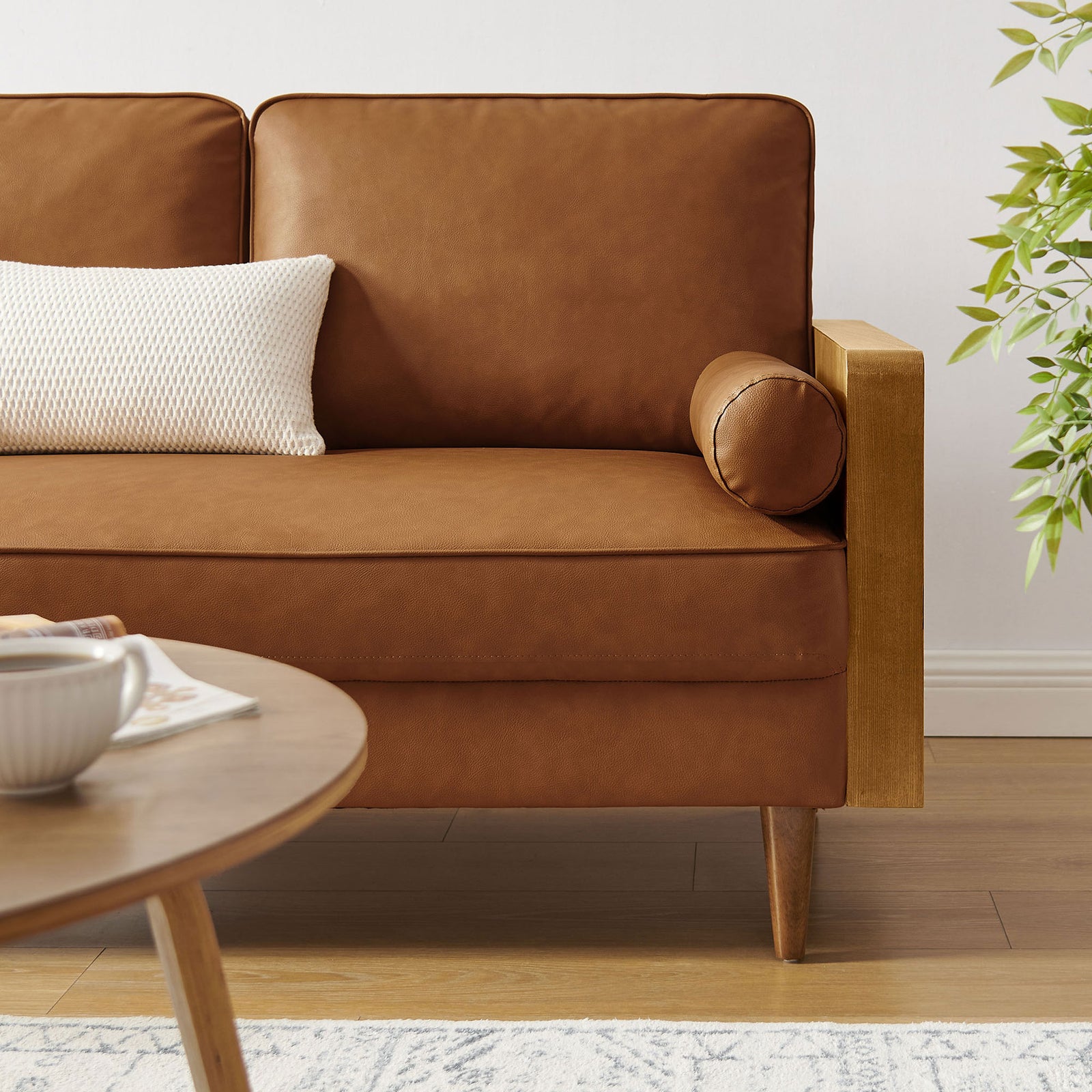 Vegan leather loveseat styled with accent pillow in a bright, modern living room setting || EEI-6943-WAL-TAN || detail_room