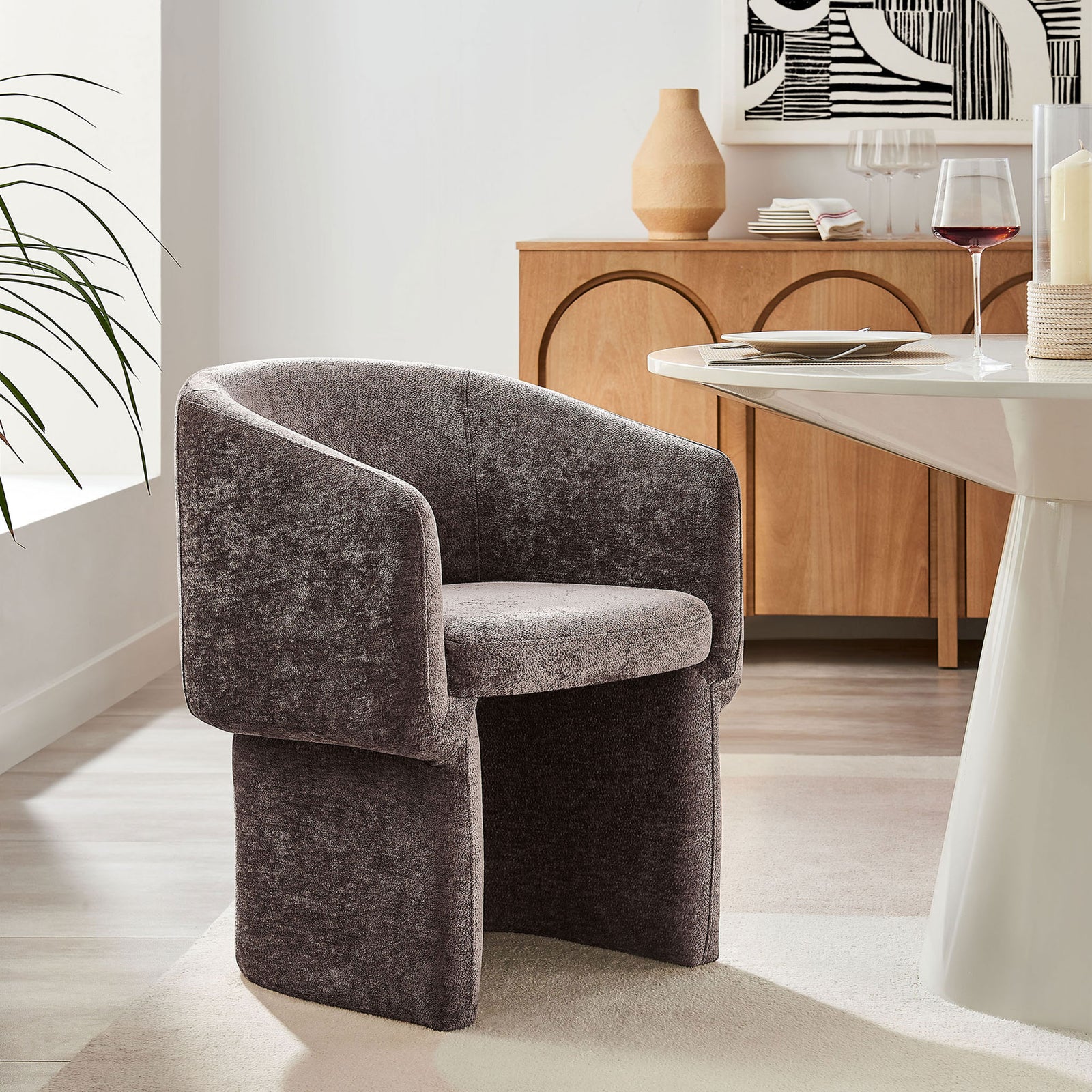 Barrel back chenille dining chair in chocolate brown completes a contemporary dining nook with sculptural table. || EEI-6951-CHB || front_angle_room
