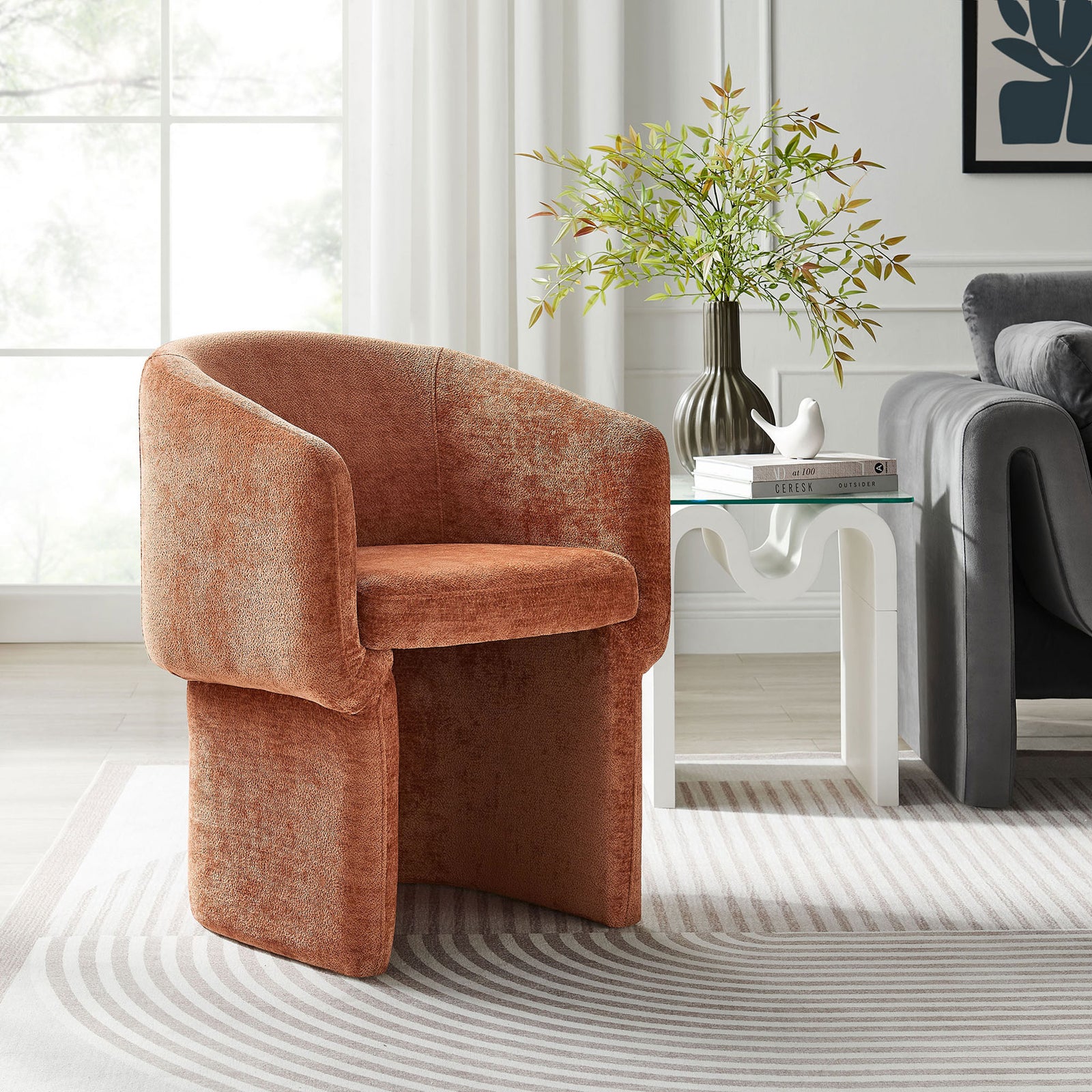 Rust chenille barrel-back armchair styled in a bright living room beside a modern white side table || EEI-6951-RUS || front_angle_room