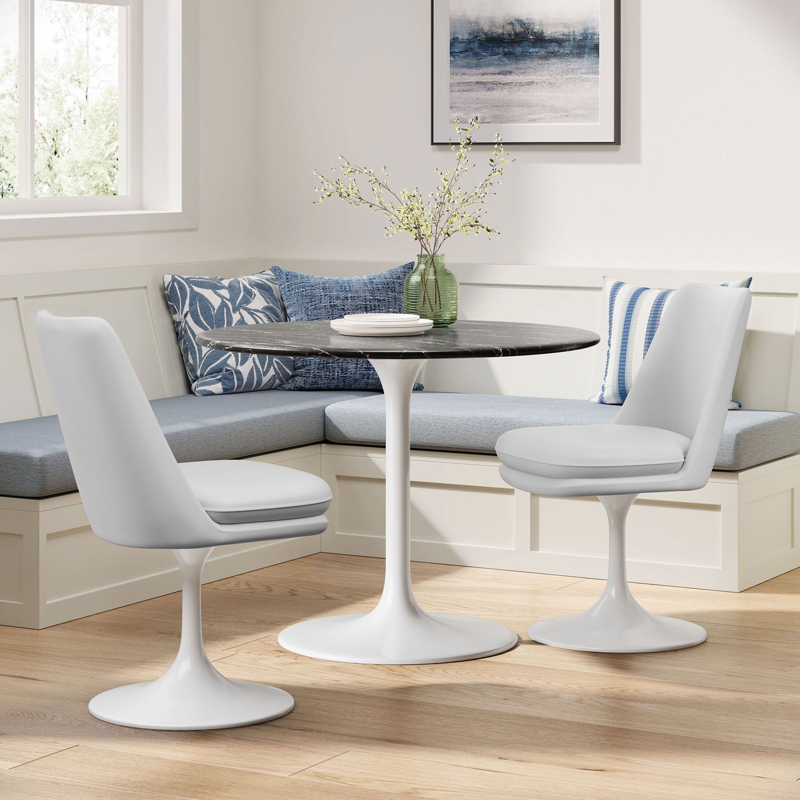 Pair of white swivel dining chairs flanking a round pedestal table in a bright nook with built-in bench seating || EEI-6955-WHI-WHI || front_angle_room