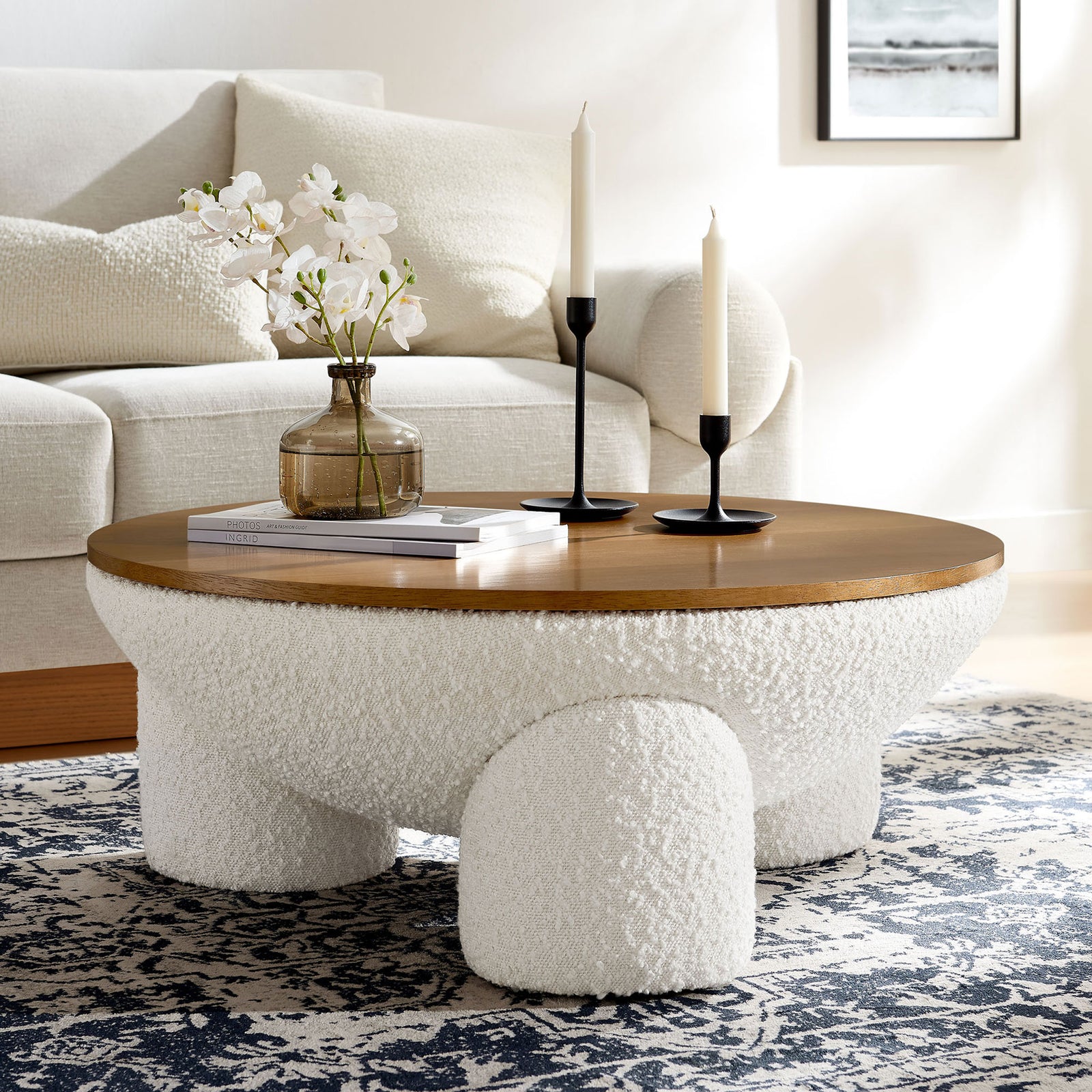 Modern round coffee table anchors the room with boucle texture and a smooth wood surface || EEI-6964-NAT-IVO || front_angle_room
