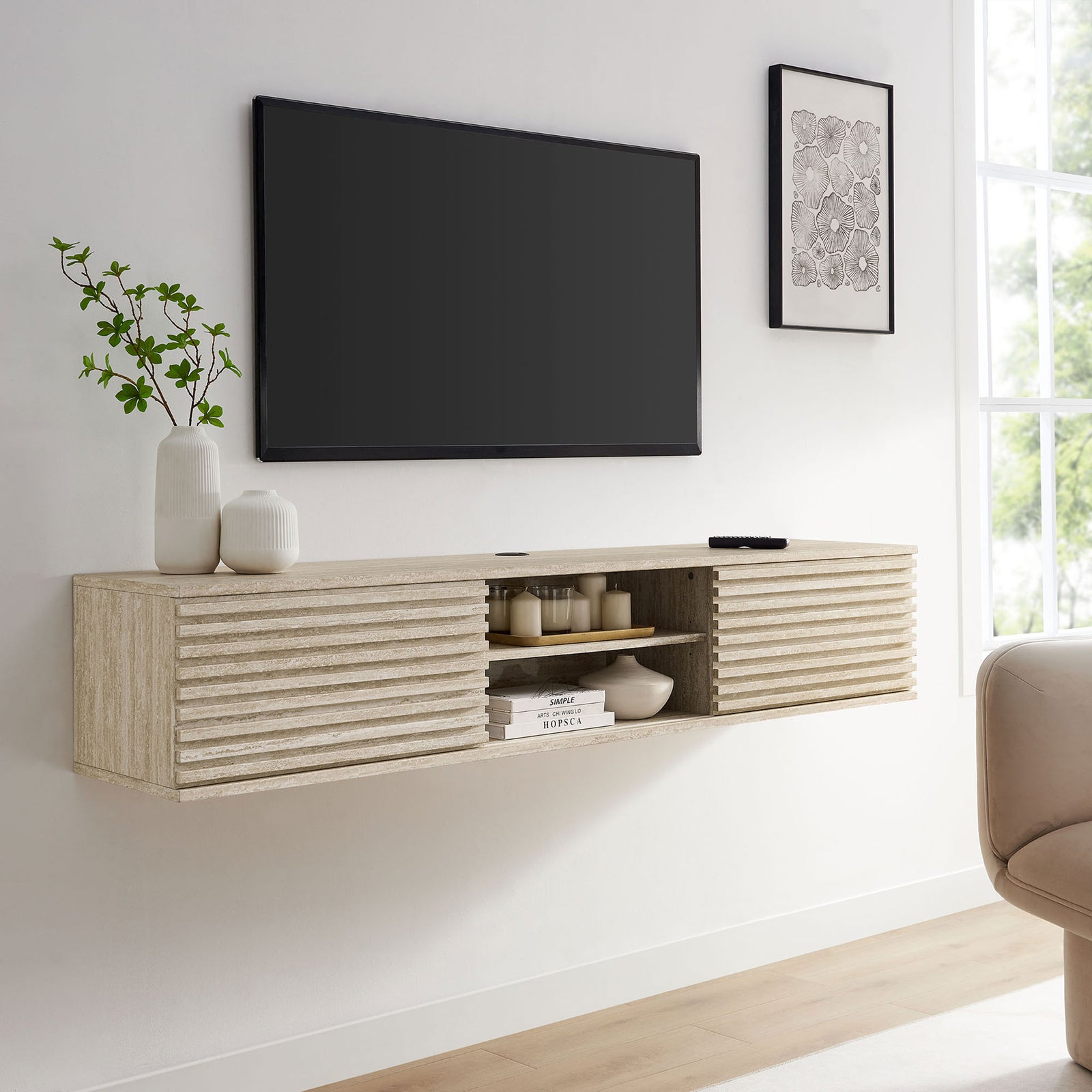 Faux travertine floating media console styled in a bright living room beneath a wall-mounted TV. || EEI-6965-TRA || front_angle_room