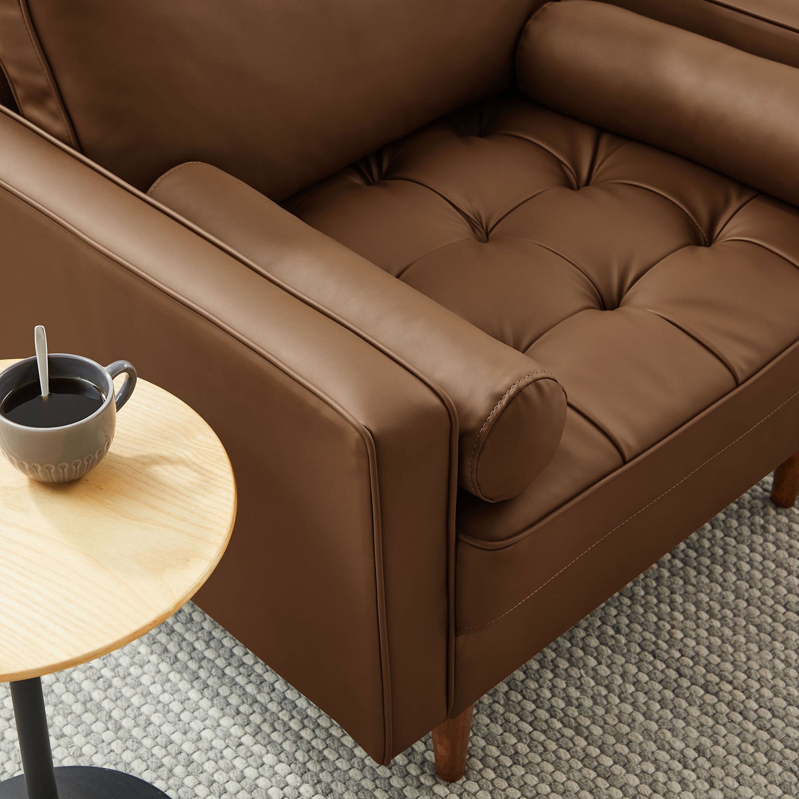 Plush tufted seat and bolster pillow offer cozy comfort in a warm brown vegan leather finish || EEI-6971-BRN || detail_room