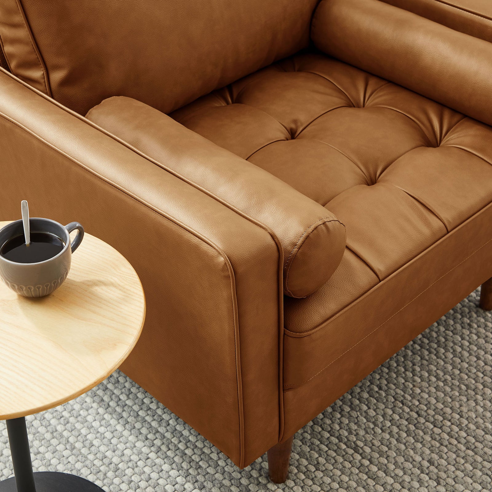 Supportive bolster pillow and tailored armrest pair with a tufted seat in rich tan vegan leather || EEI-6971-TAN || detail_room