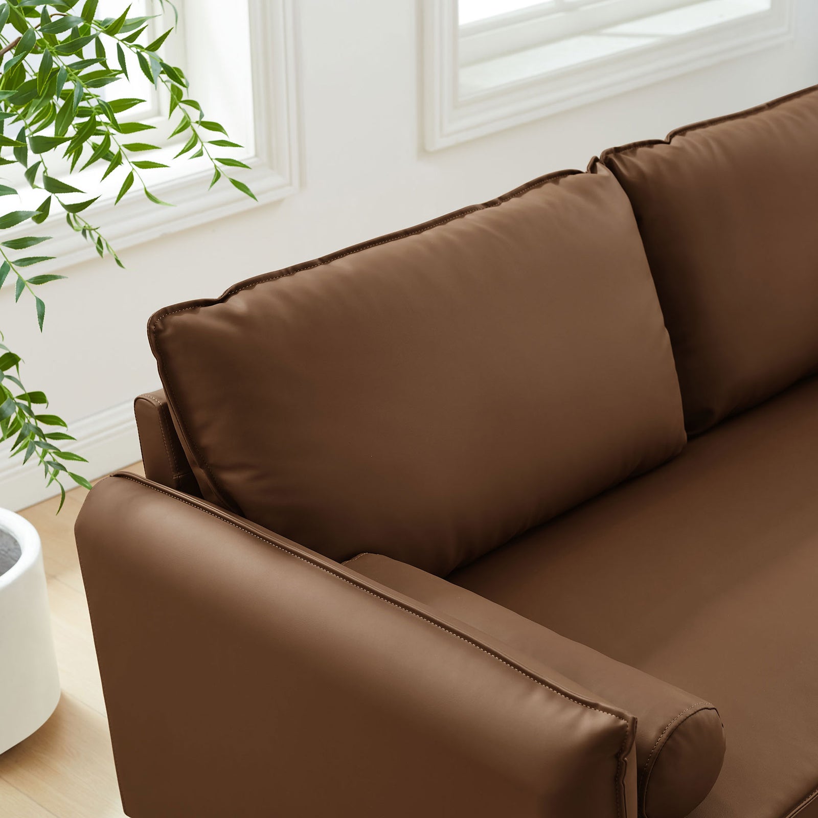 Plush back cushions and smooth vegan leather seat offering relaxed, supportive comfort. || EEI-6975-BRN || detail_room