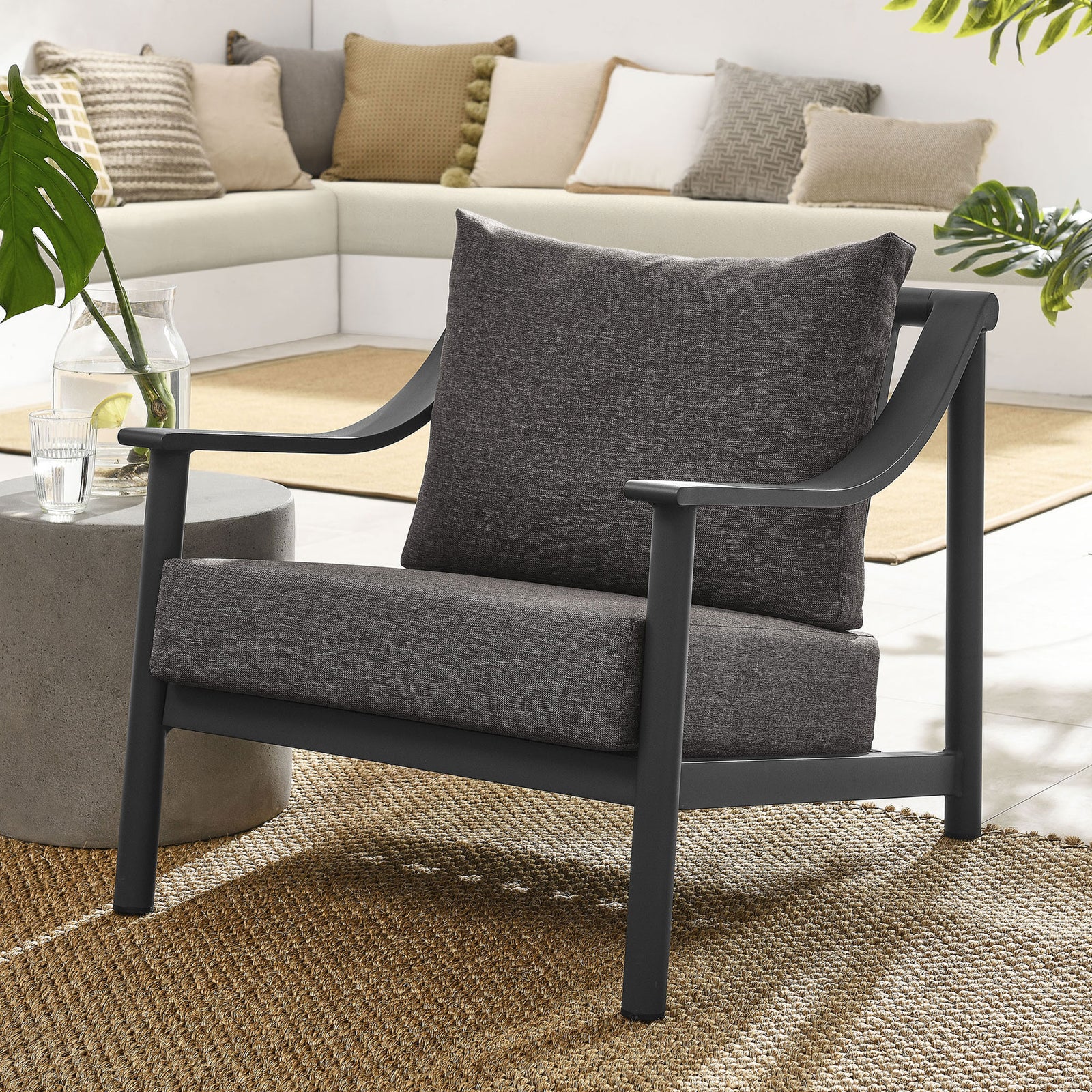 Terrace outdoor accent armchair styled with layered neutral cushions for a cozy modern patio seating area || EEI-6976-CAR-GPH || front_angle_room