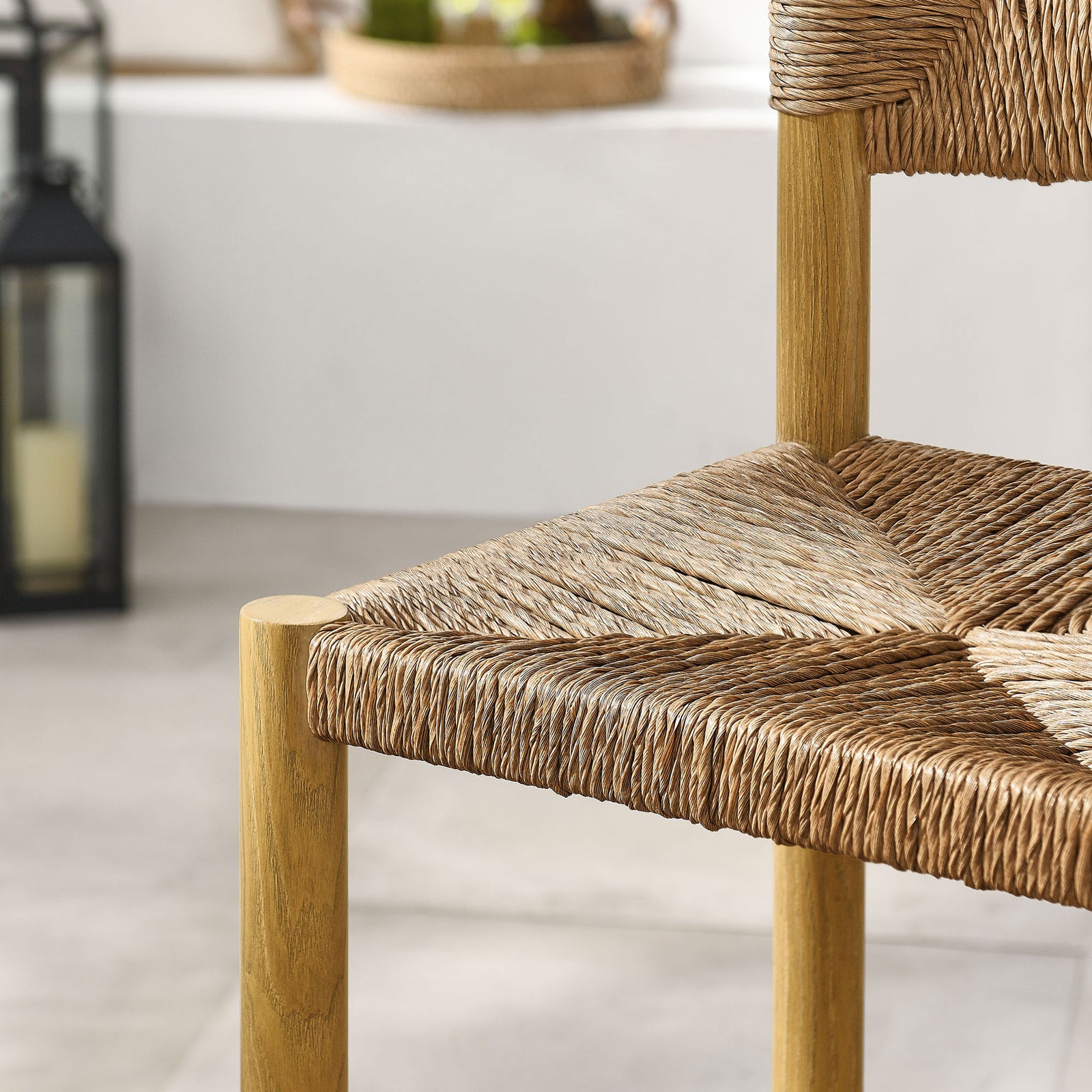 Woven rattan seat pattern pairs with sunlit patio surroundings for an organic outdoor look || EEI-6983-NAT || swatch_room