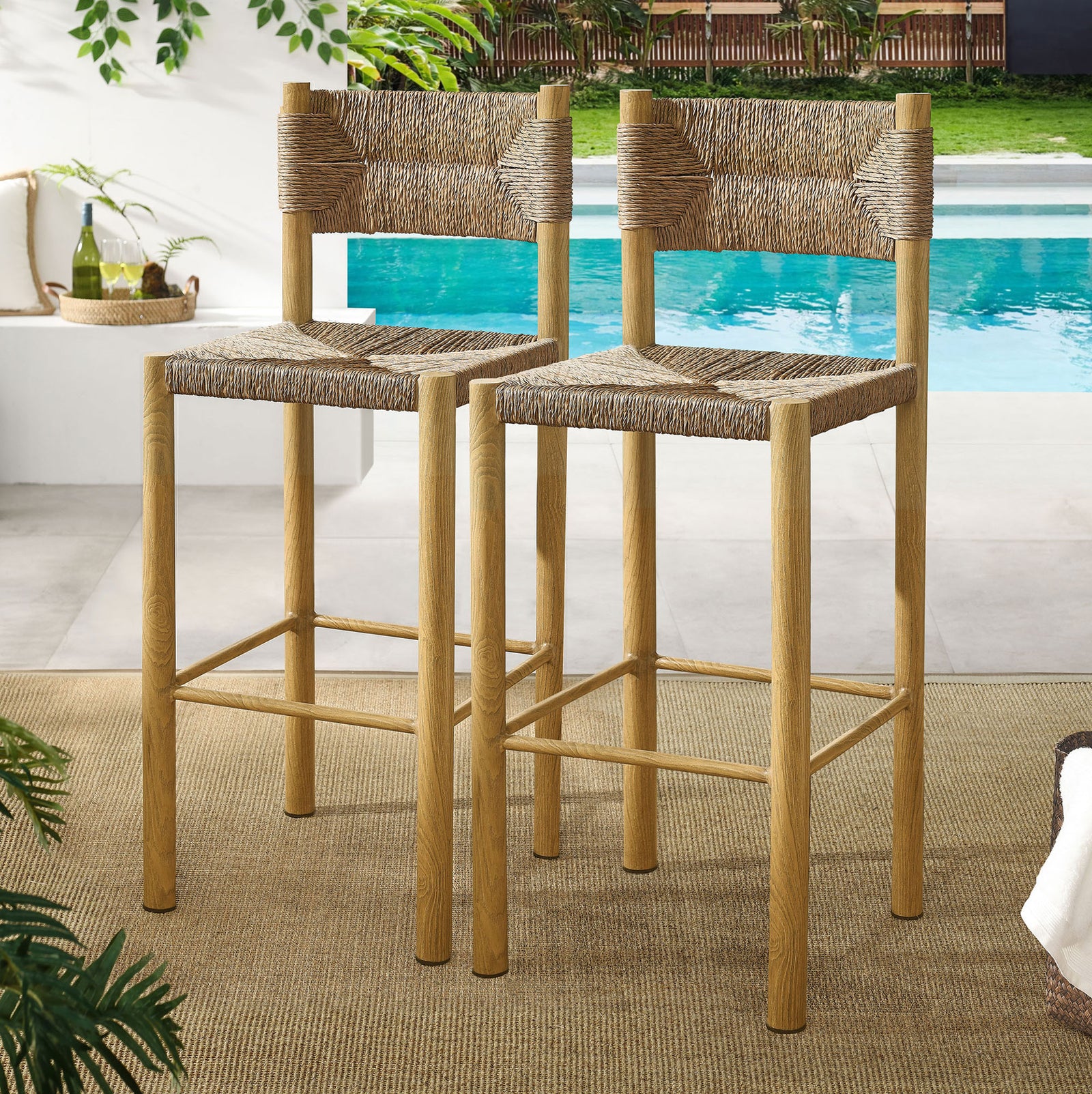 Pair of bar stools frames an outdoor counter, blending rattan texture with a resort-inspired patio || EEI-6984-NAT || front_angle_multi_room
