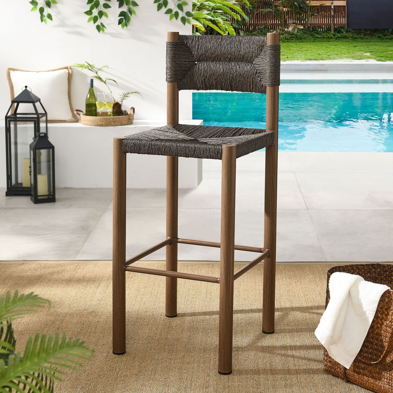Walnut bar stool adds height and rich texture beside a breezy poolside bar || EEI-6984-WAL || front_angle_room