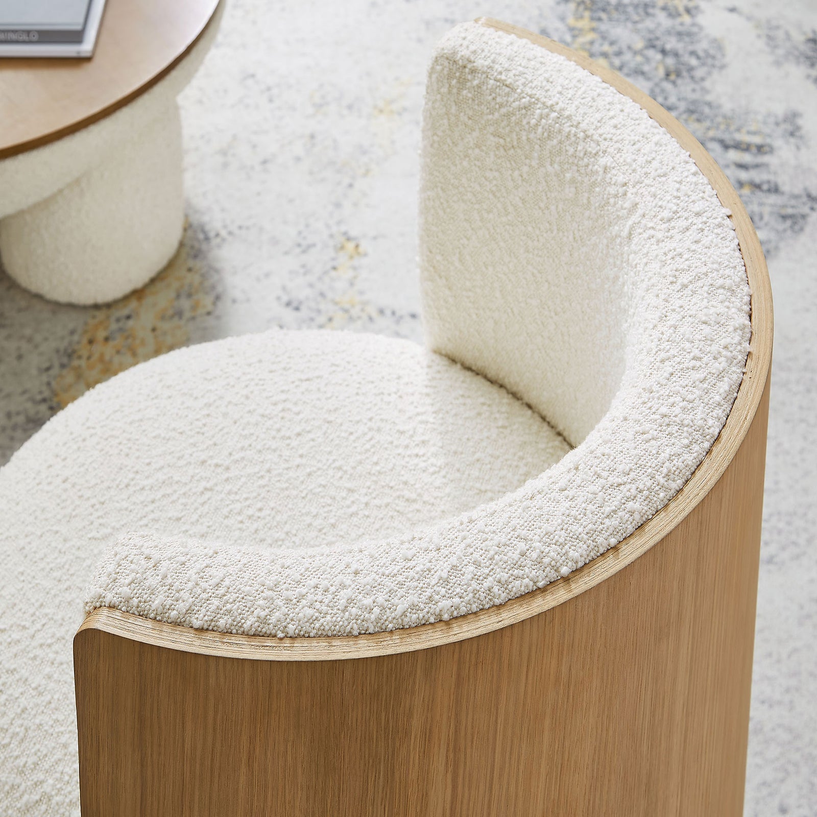 Textured boucle wraps the curved backrest for cozy comfort and tactile appeal || EEI-6994-NAT-IVO || detail_room