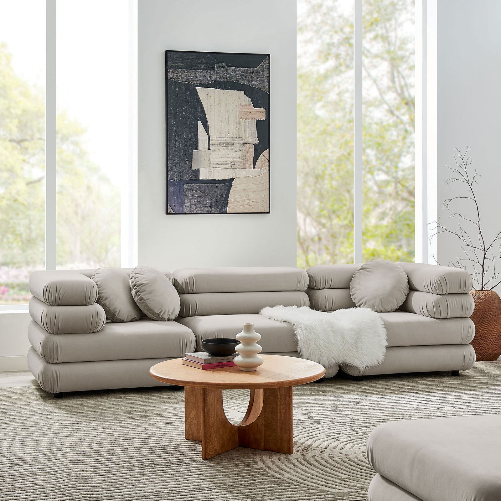 Almond velvet modular sectional styled in a bright living room with wood coffee table and soft rug || EEI-7003-ALM || front_angle_room