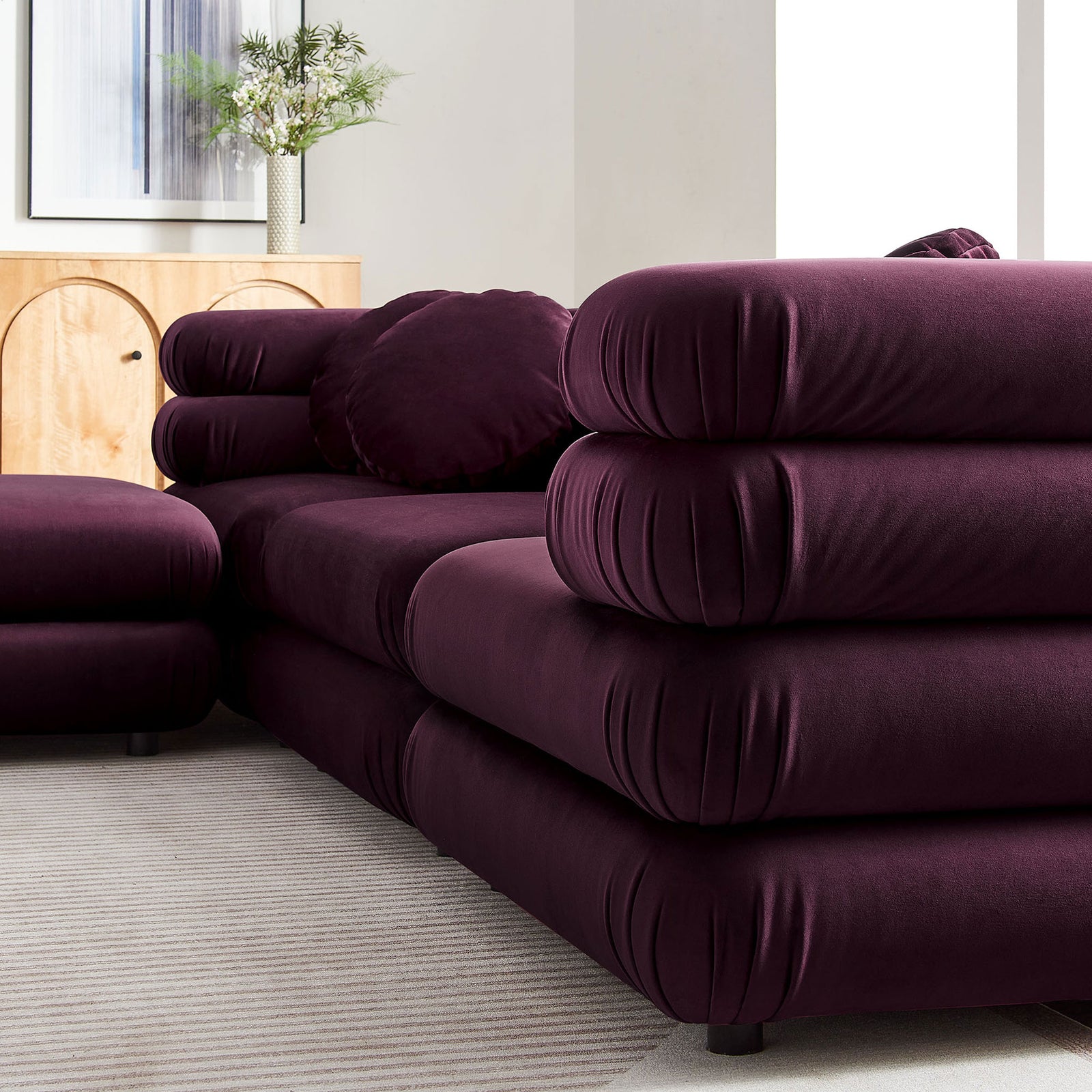 Soft performance velvet upholstery and stacked rounded cushions highlight the luxe texture of the mulberry sectional || EEI-7004-MUL || detail_room
