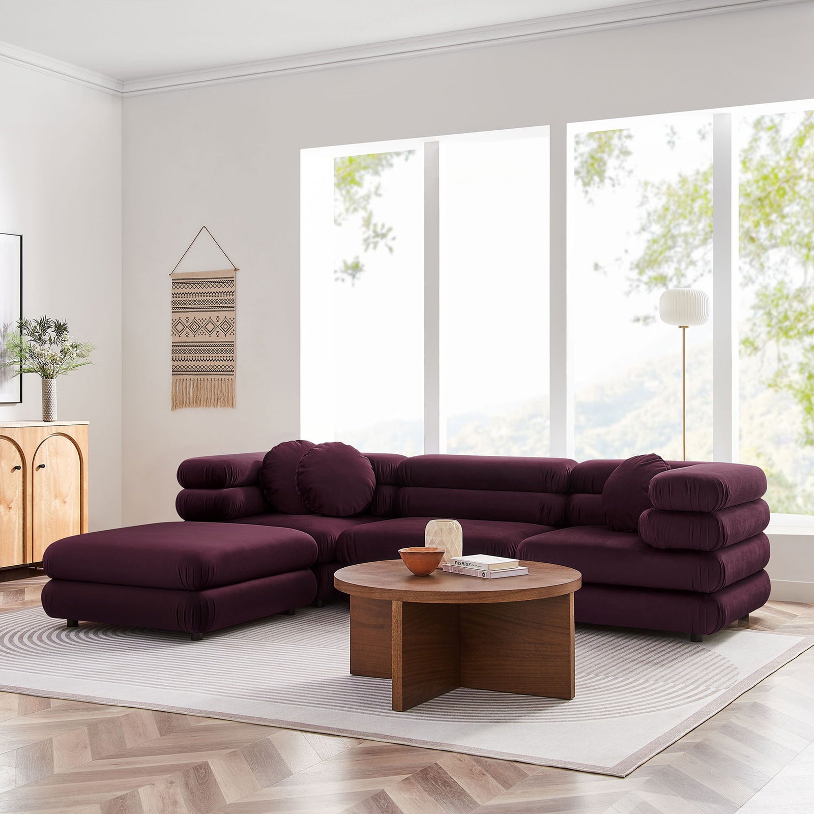 Mulberry velvet sectional anchors a bright living room with spacious chaise lounge and inviting low-profile silhouette || EEI-7004-MUL || front_angle_room