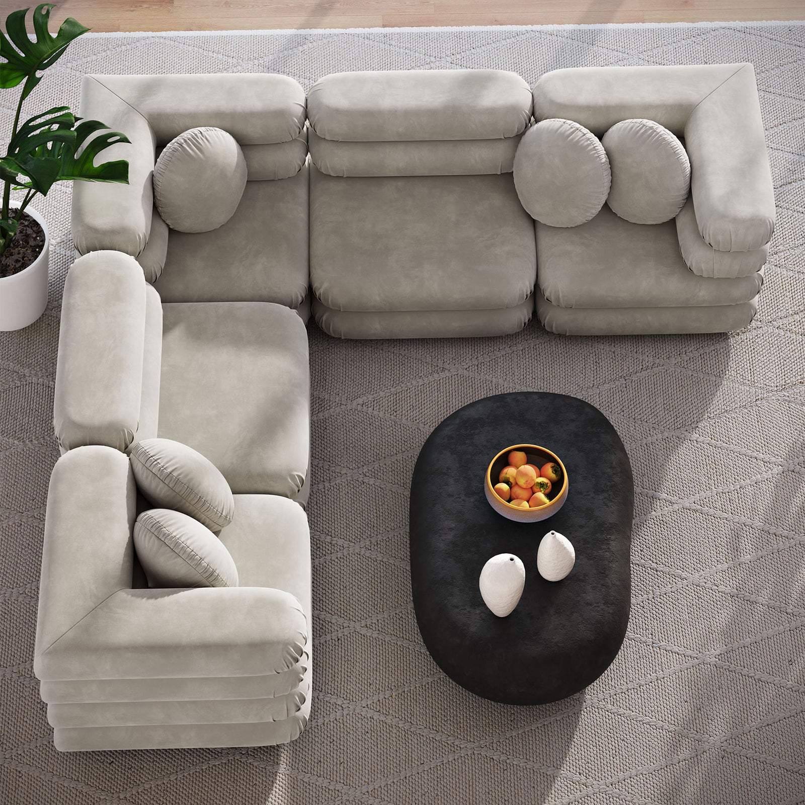 Almond sectional sofa arranged in an L shape over a patterned rug with a dark oval coffee table || EEI-7005-ALM || top_room