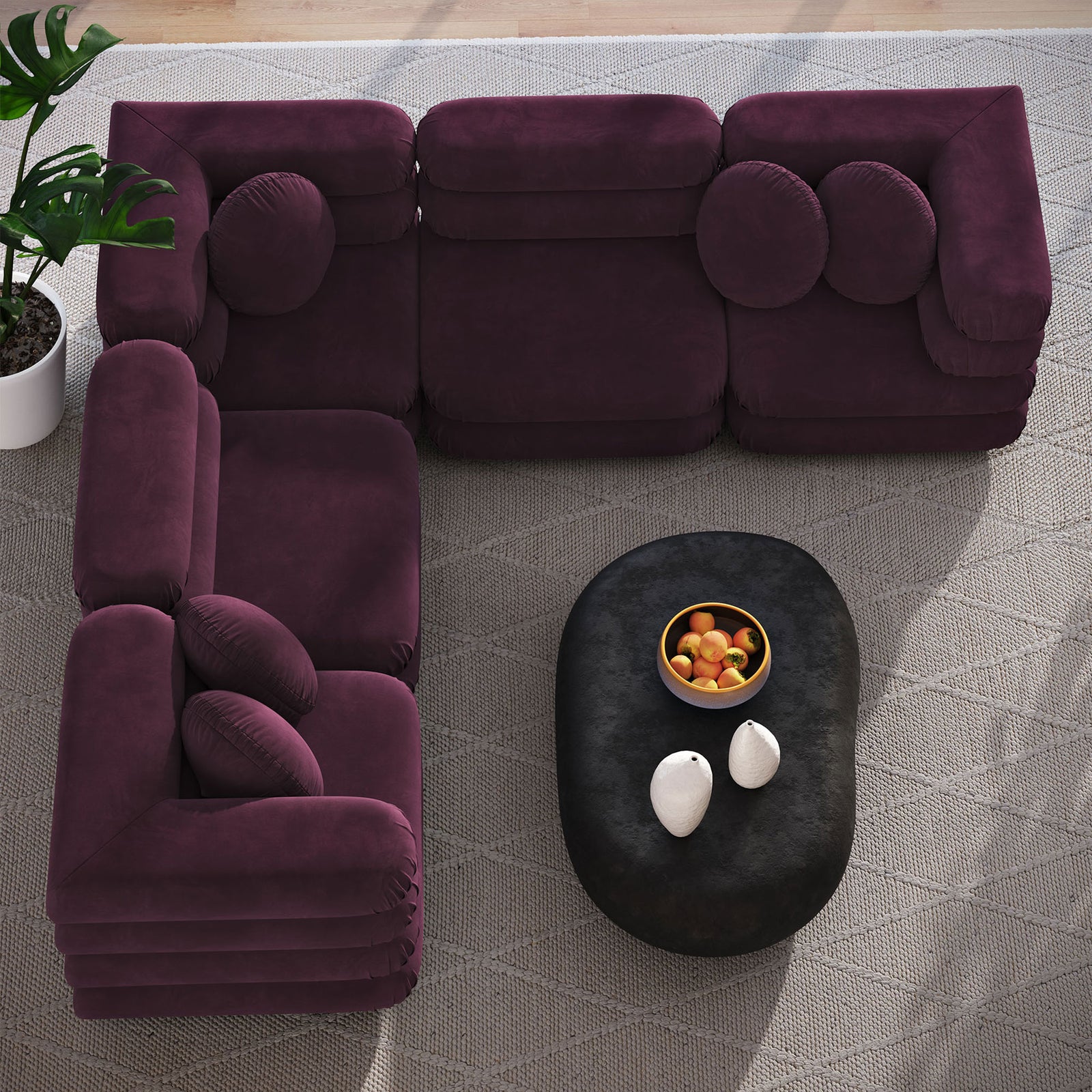 Modular mulberry velvet sectional arranged around an oval black coffee table on a textured area rug || EEI-7005-MUL || top_room