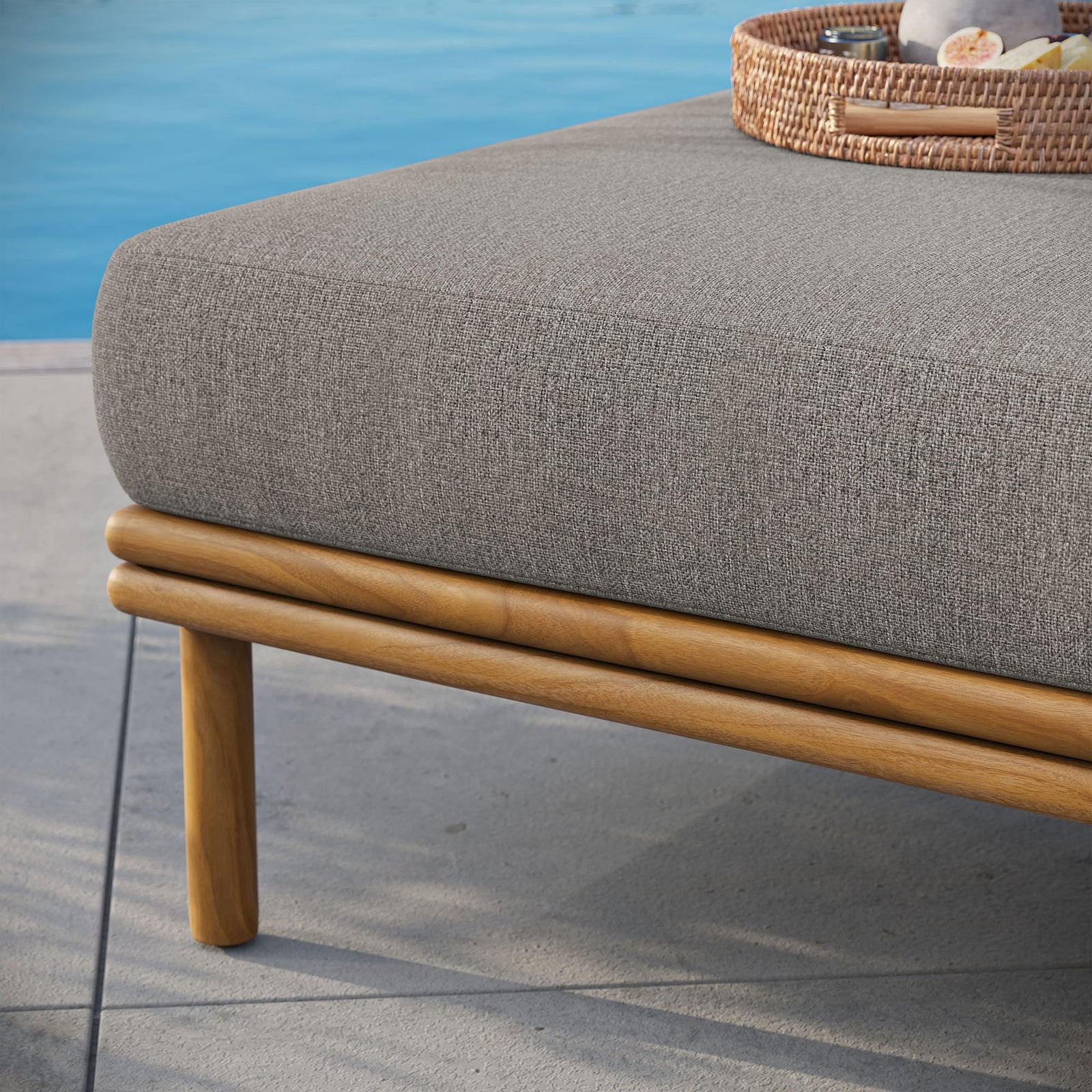 Teak base and soft cushion sit on a sunlit patio, ready to pair with your favorite outdoor seating pieces. || EEI-7009-NAT-DRI || detail_room