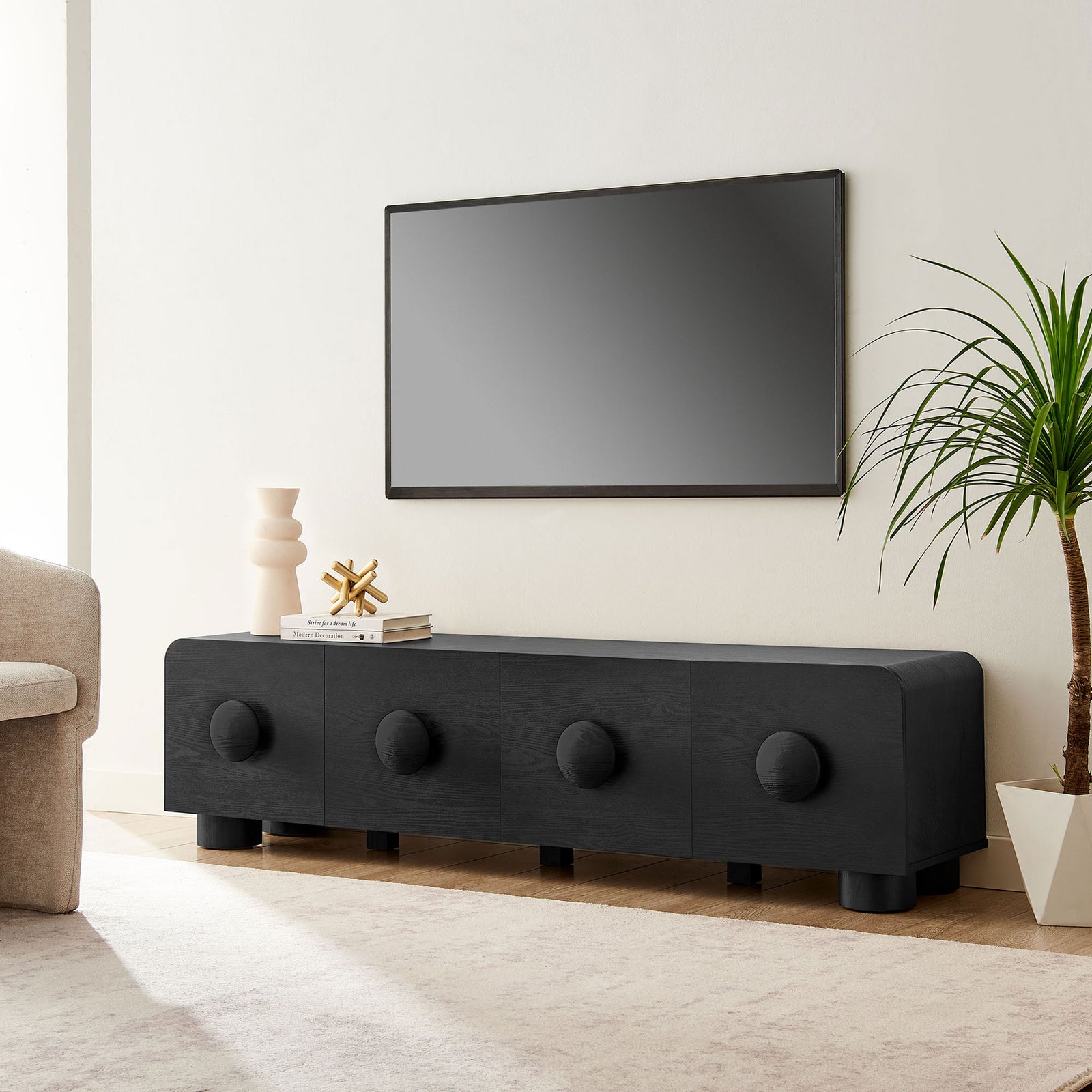 Black Sonnet media console styled under a wall-mounted TV in a clean modern living room || EEI-7011-BLK || front_angle_room