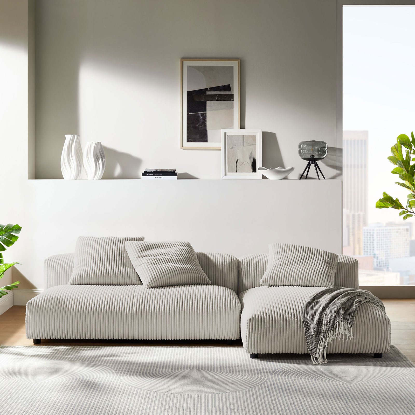 Low-profile almond corduroy sectional with chaise and pillows in a bright modern living room || EEI-7024-ALM || front_angle_room