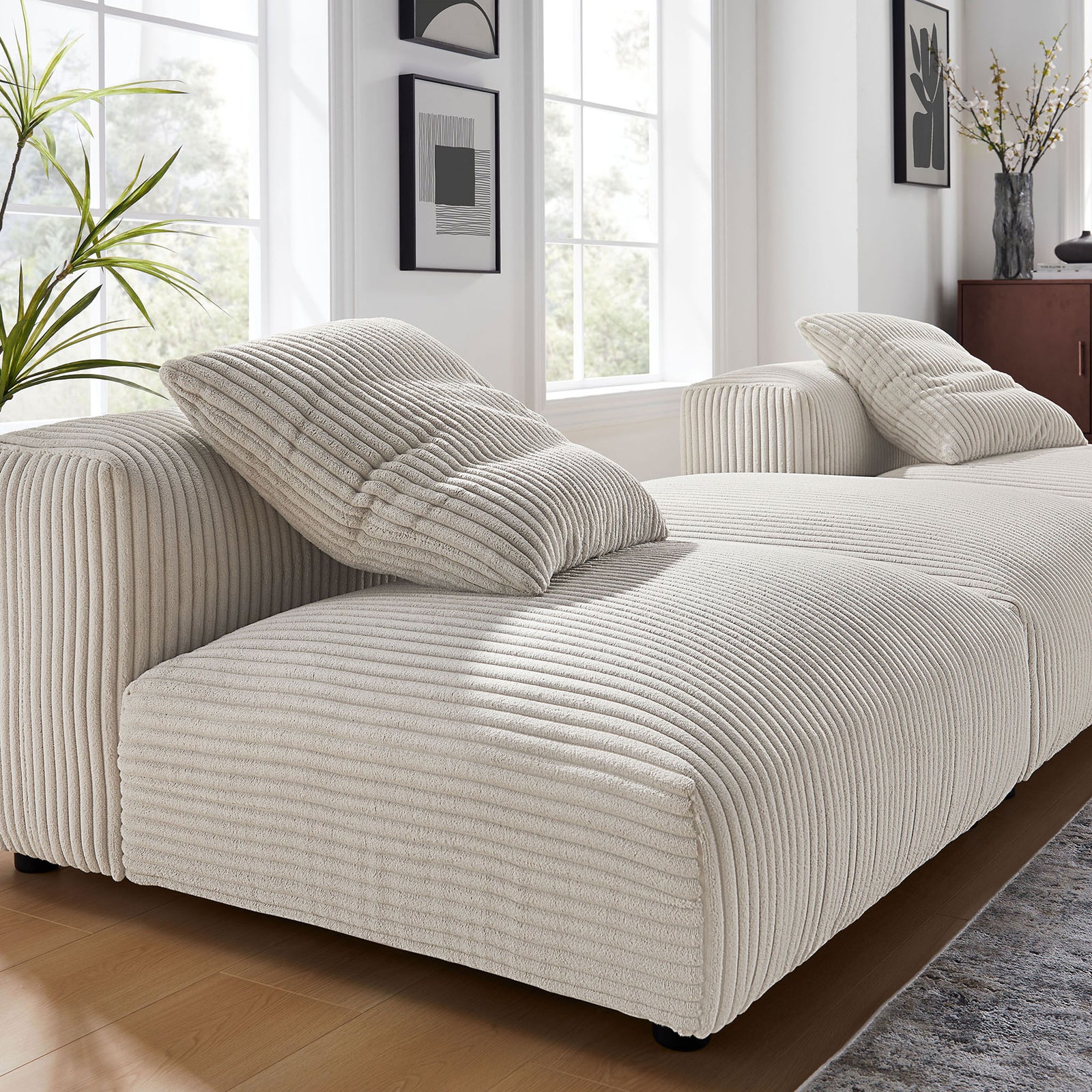 Soft ribbed corduroy upholstery and plush cushions create an inviting lounge-ready seating surface || EEI-7028-ALM || detail_room