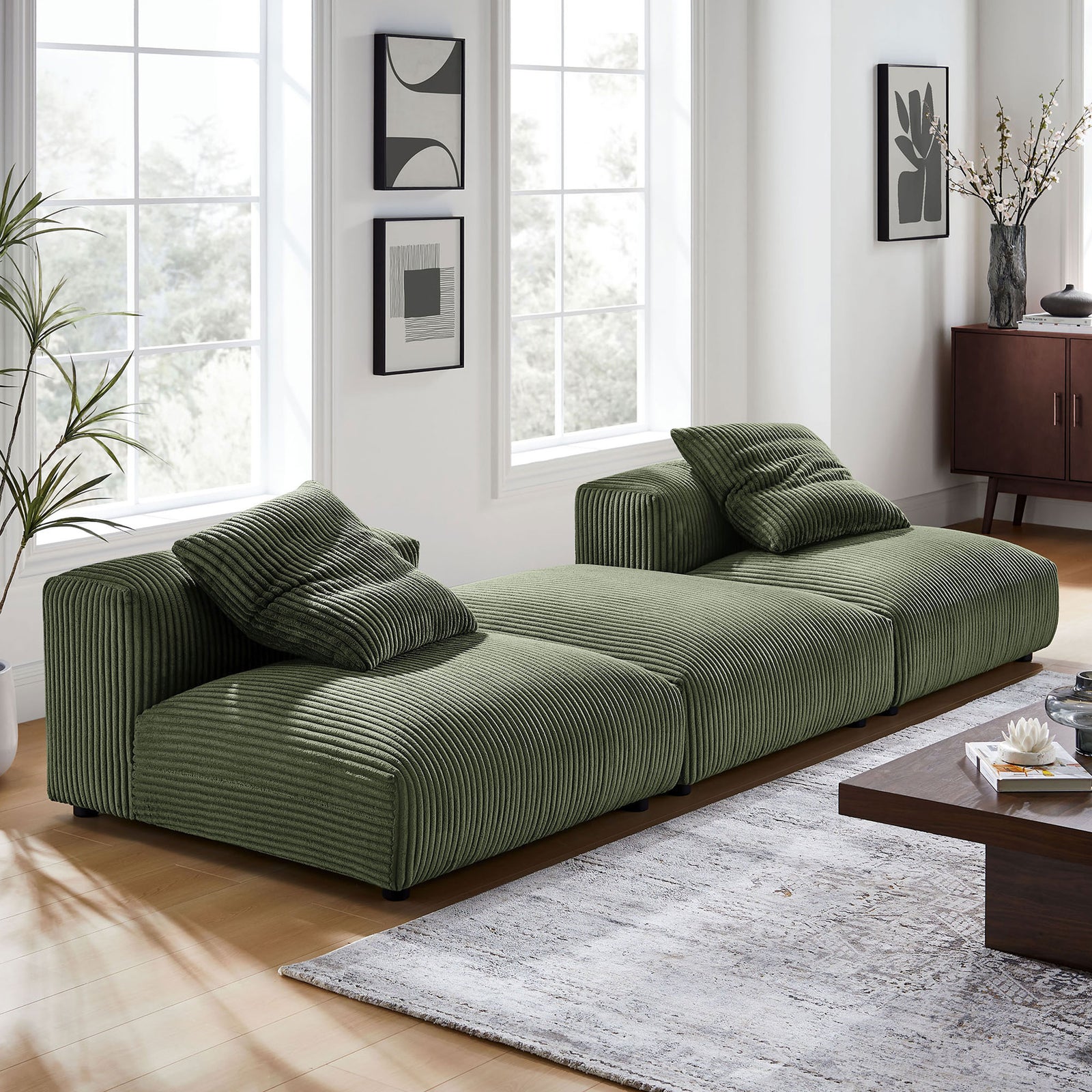 Fern green corduroy modular sectional anchored in a modern living room with neutral rug and sleek decor. || EEI-7028-FRN || front_angle_room