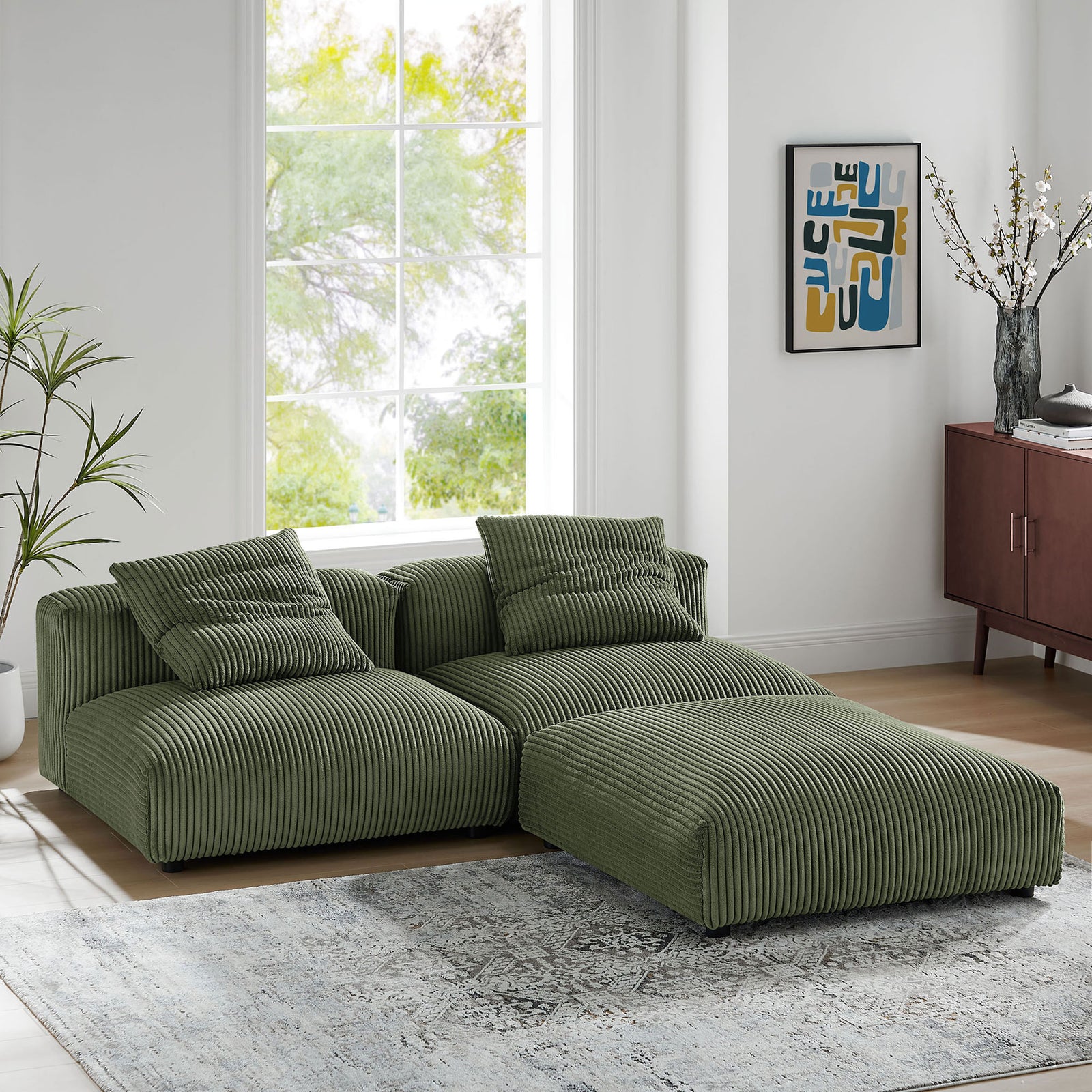 Fern corduroy sectional in an L-shaped layout, shown in a sunlit living room with artful accents and soft textures. || EEI-7028-FRN || front_angle_room