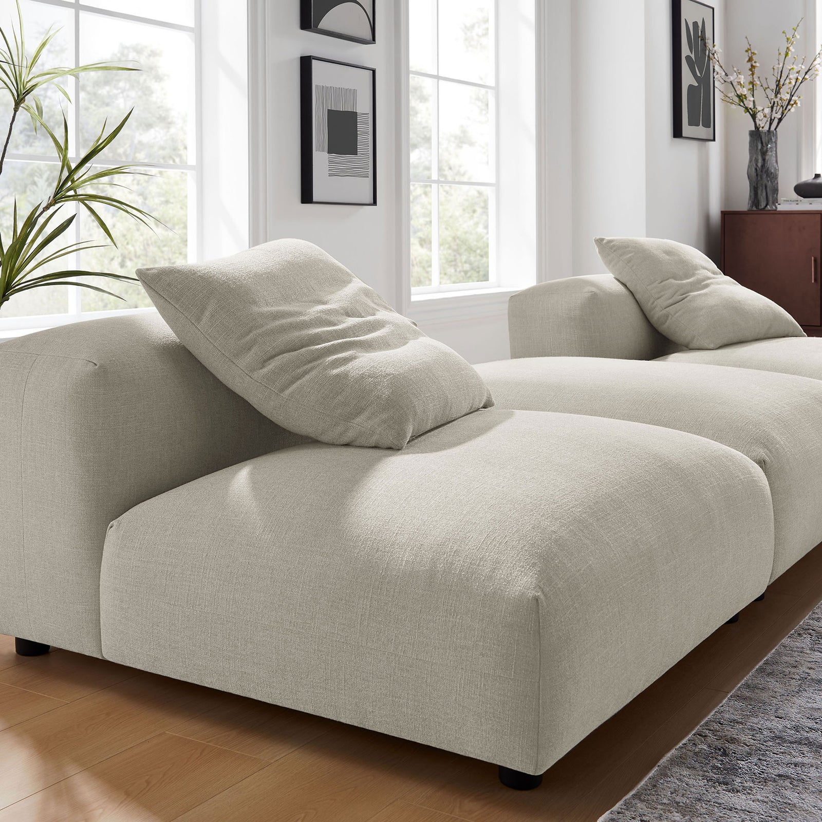 Textured linen upholstery and plush cushioning on the deep seat of the modular sectional || EEI-7029-LIN || detail_room
