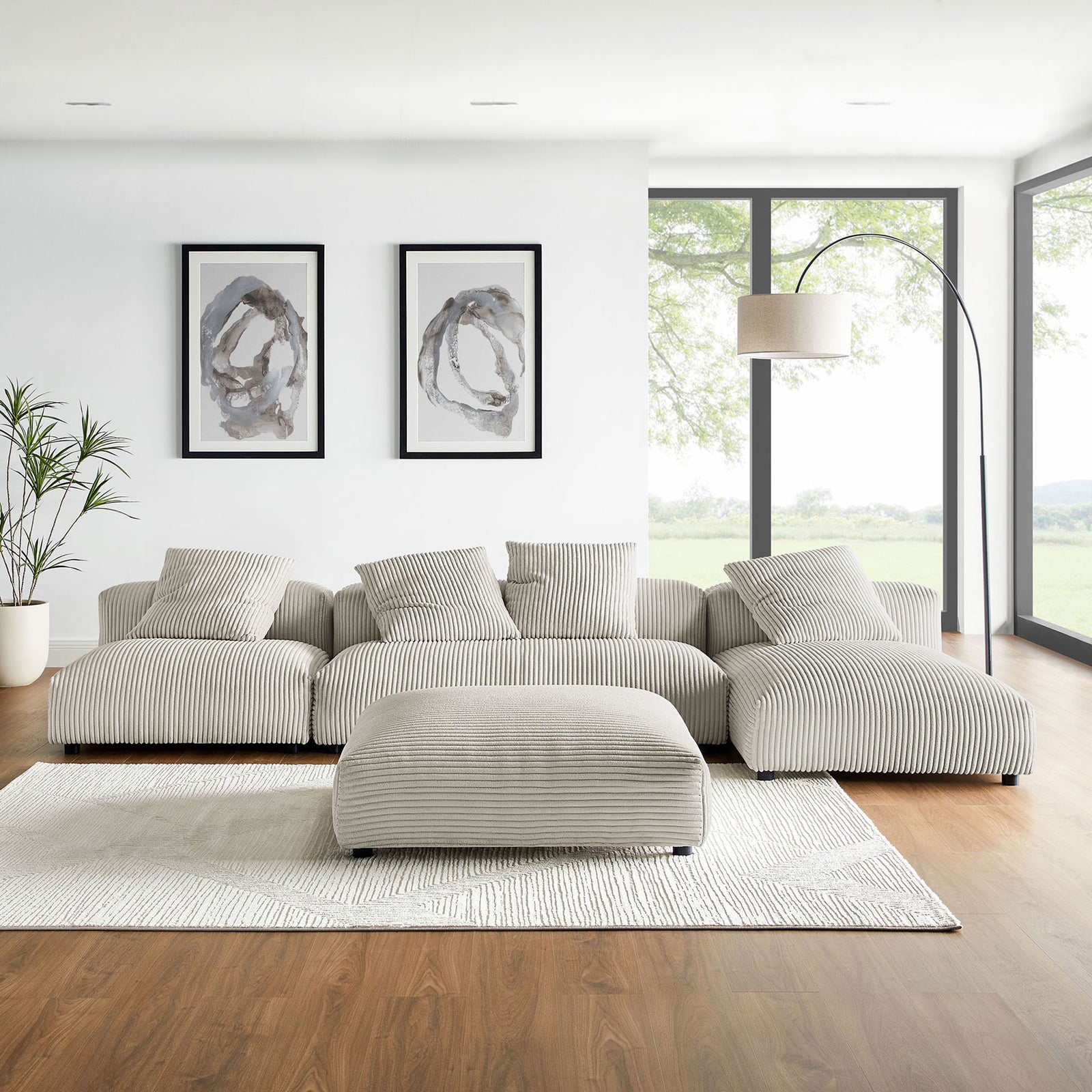 Almond corduroy sectional with ottoman styled in a bright living room with rug, floor lamp, and wall art || EEI-7032-ALM || front_room