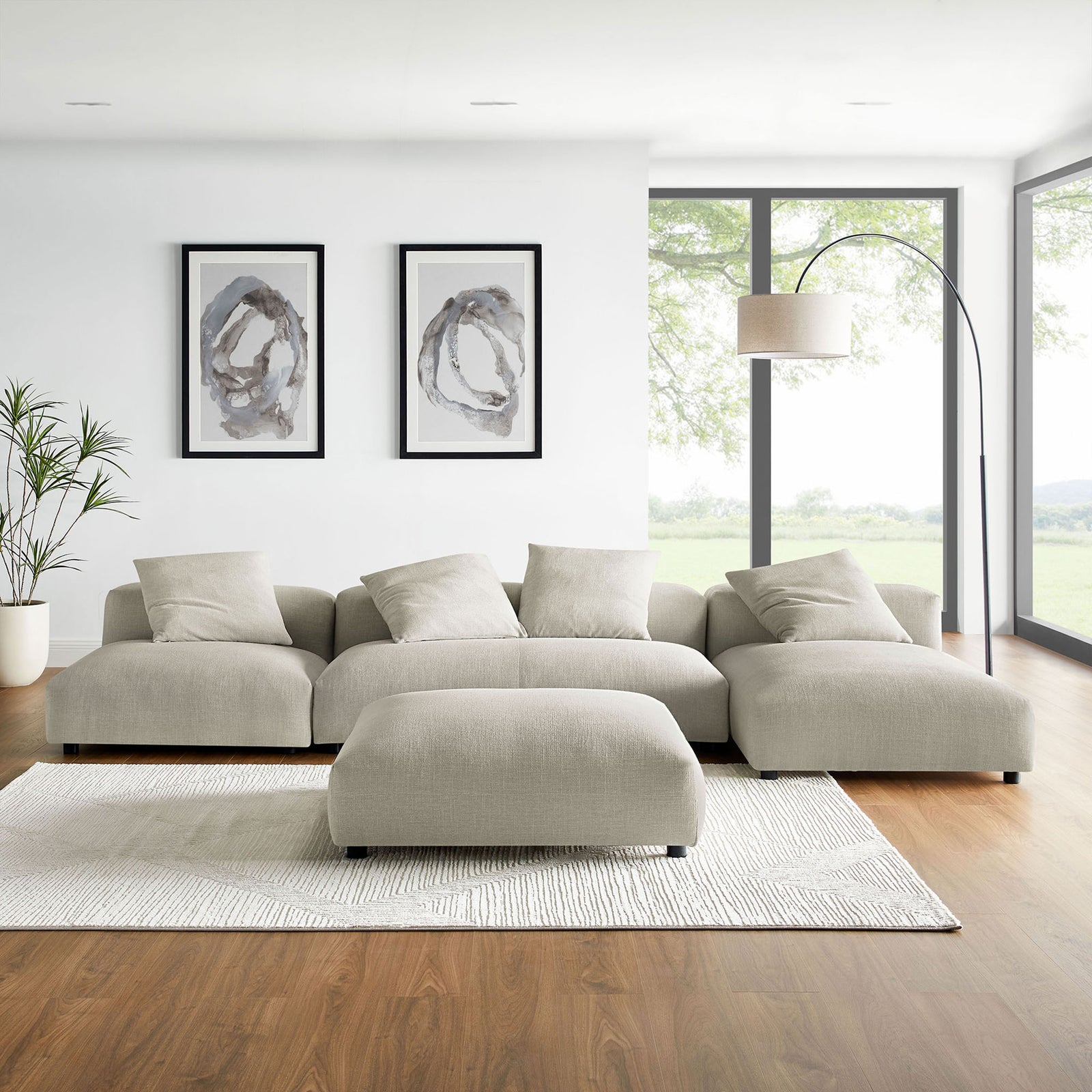 Linen modular sectional sofa and ottoman styled with area rug, floor lamp, and wall art || EEI-7033-LIN || front_room