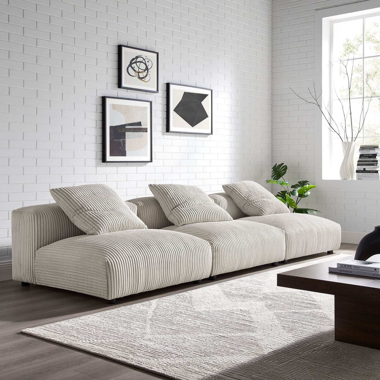 Almond corduroy modular sofa anchors a bright modern living room with low-profile seating and layered texture || EEI-7034-ALM || front_angle_room