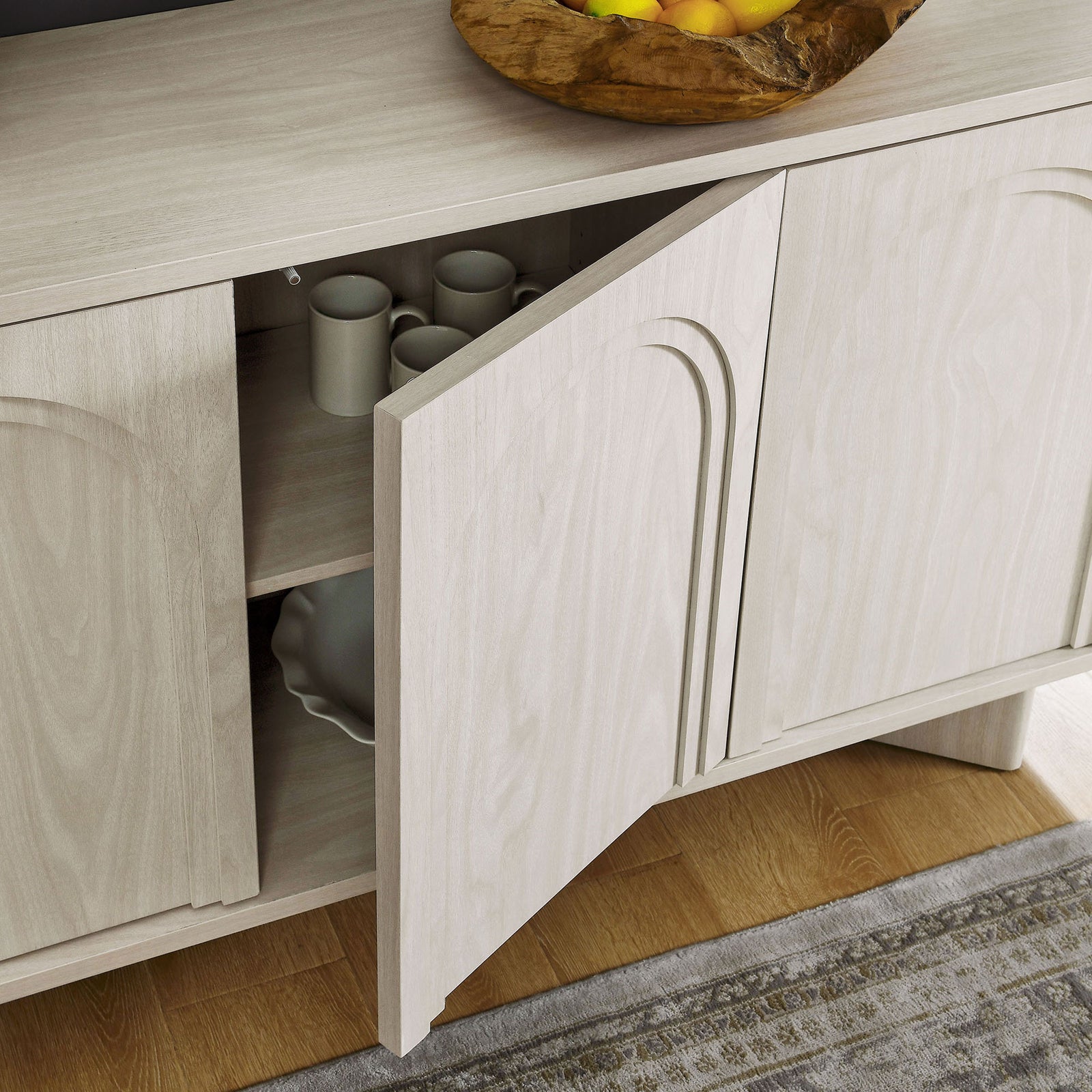 Open sideboard cabinet showing dinnerware stored on adjustable shelves in the white wash interior || EEI-7039-WWA || storage_open_room