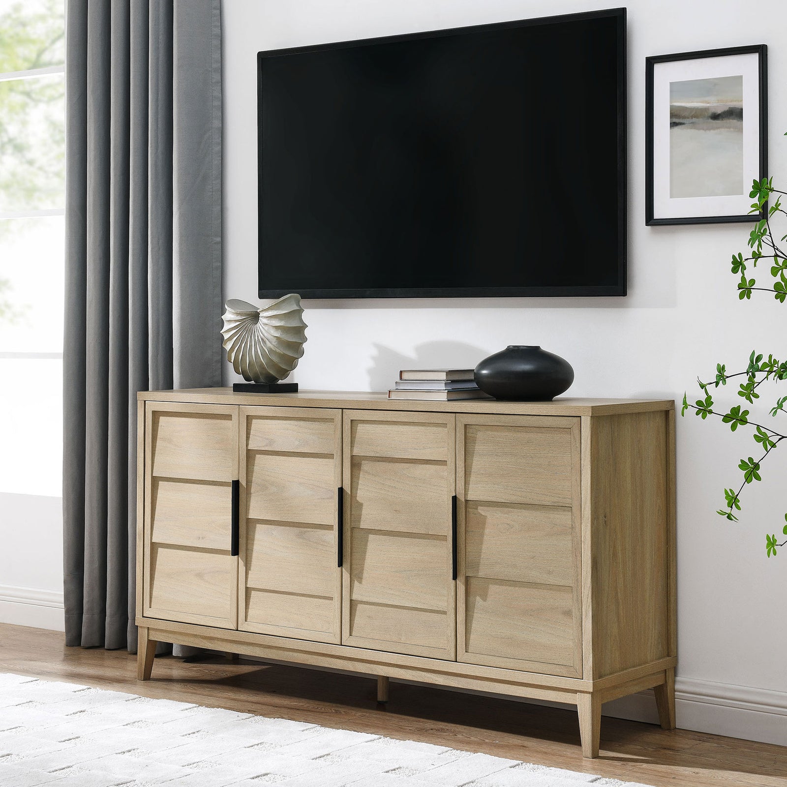 Sinya sideboard styled as a media console beneath a wall-mounted TV with modern decor accents. || EEI-7040-LOA || front_angle_room